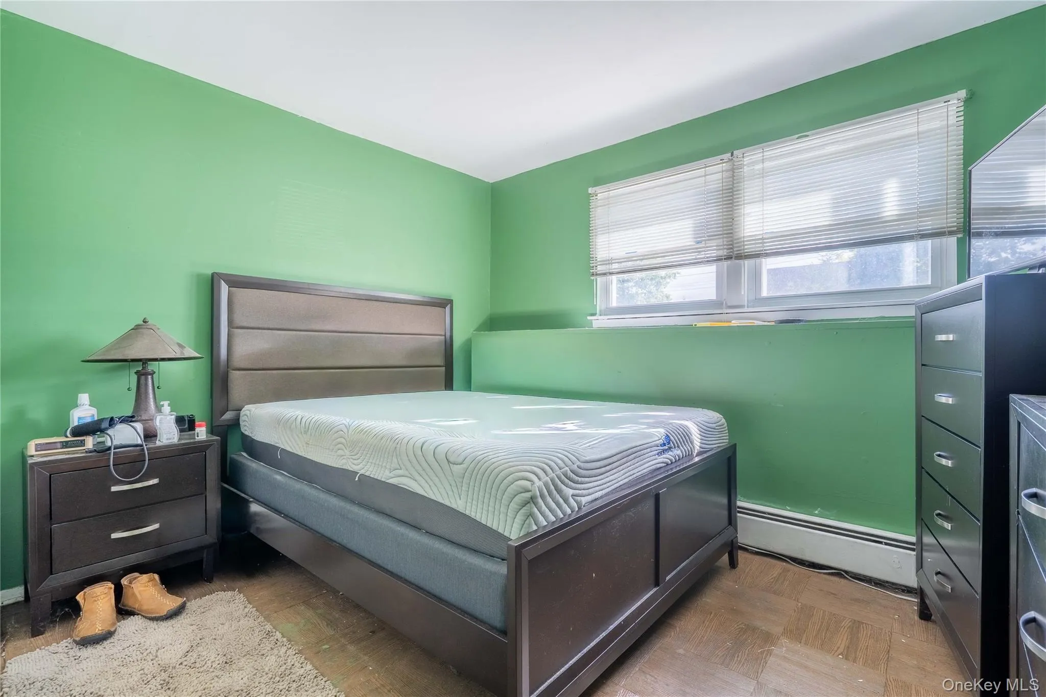 Parquet wood-finish flooring, dual-pane windows with horizontal blinds, and a deep windowsill ledge Parquet wood-finish flooring, dual-pane windows with horizontal blinds, and a deep windowsill ledge