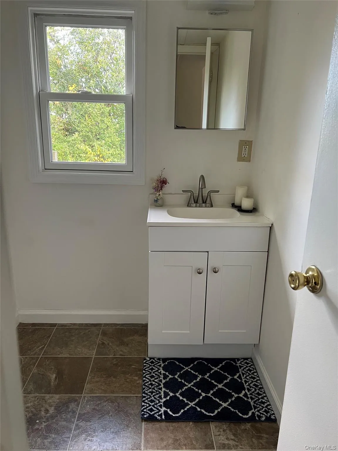 Bathroom featuring vanity and baseboards Bathroom featuring vanity and baseboards
