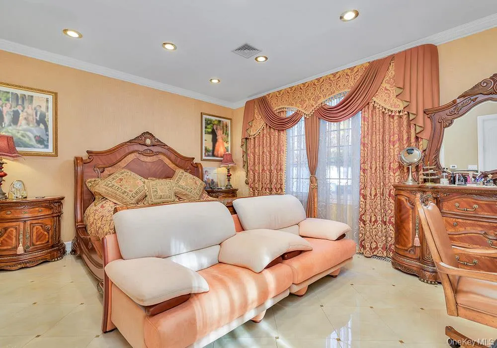 Spacious room featuring recessed lighting, large windows with full-length drapery, and polished tile flooring with decorative inlay accents Spacious room featuring recessed lighting, large windows with full-length drapery, and polished tile flooring with decorative inlay accents