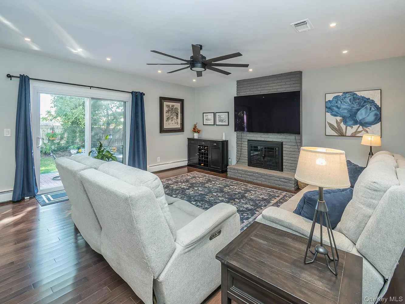 Family room/ Den with sliders to outdoor patio and yard Family room/ Den with sliders to outdoor patio and yard