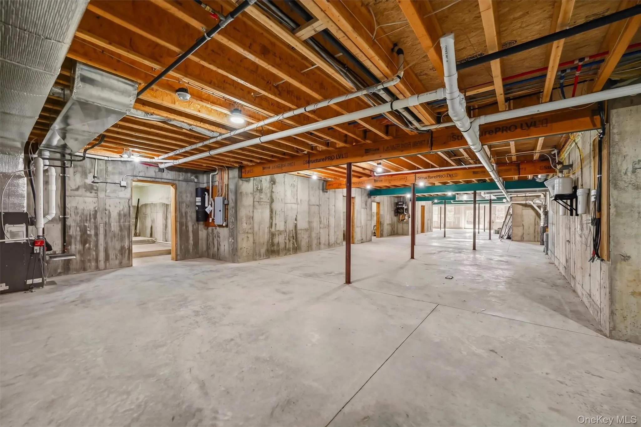 Unfinished lower level featuring exposed wood joist ceilings, poured concrete foundation walls, and concrete flooring. High ceilings! Unfinished lower level featuring exposed wood joist ceilings, poured concrete foundation walls, and concrete flooring. High ceilings!