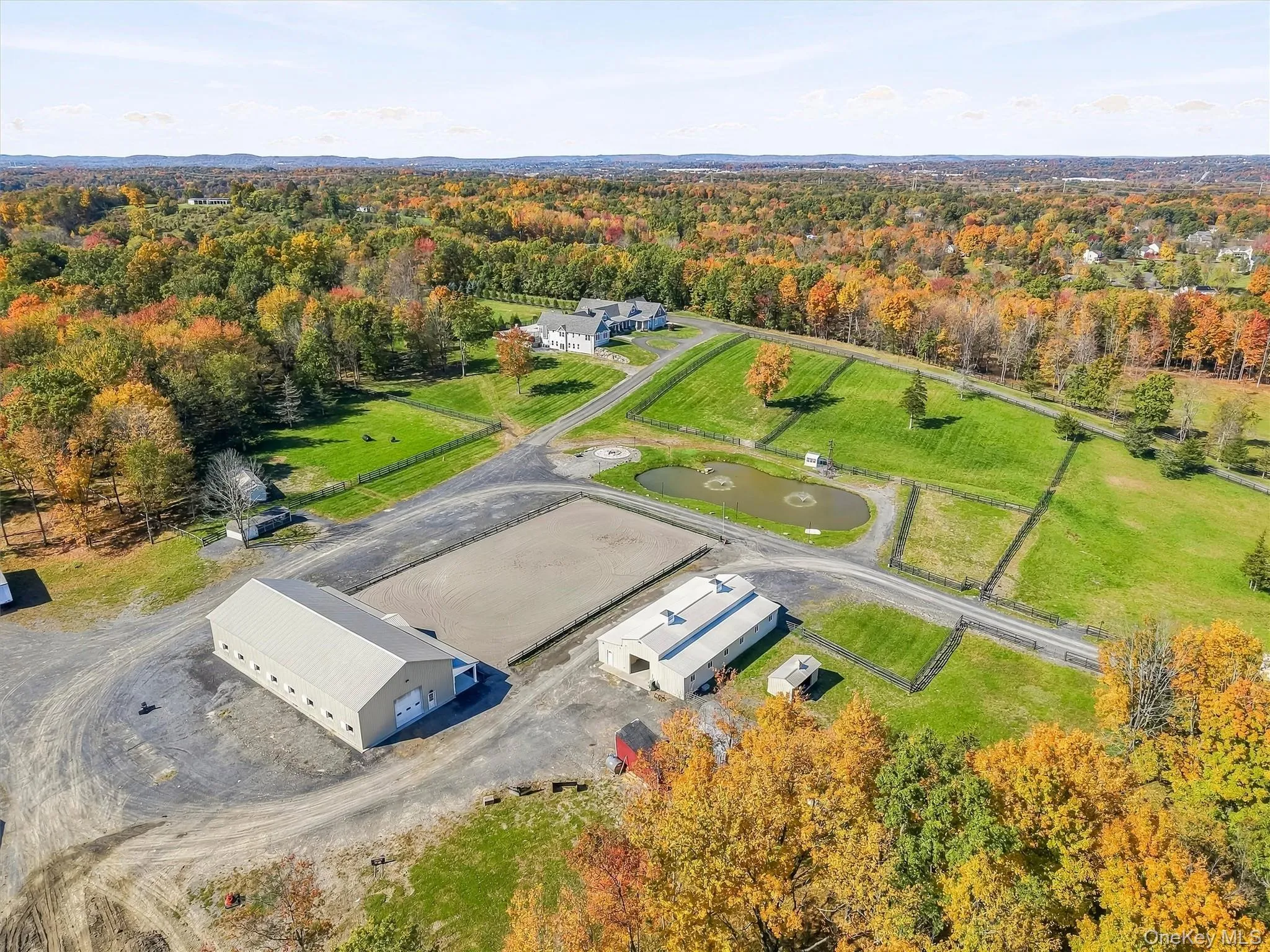 Extensive acreage featuring a large outdoor riding arena, a private pond, multiple outbuildings, and fenced pastures Extensive acreage featuring a large outdoor riding arena, a private pond, multiple outbuildings, and fenced pastures