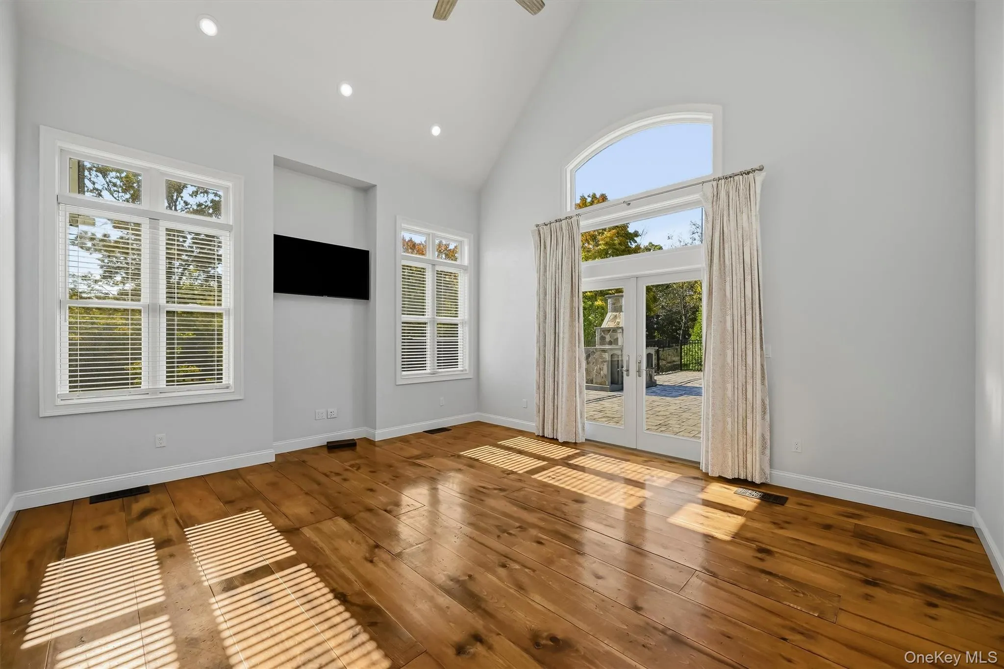 Sundrenched spacious bedroom with French doors leading ton patio andnpool Sundrenched spacious bedroom with French doors leading ton patio andnpool
