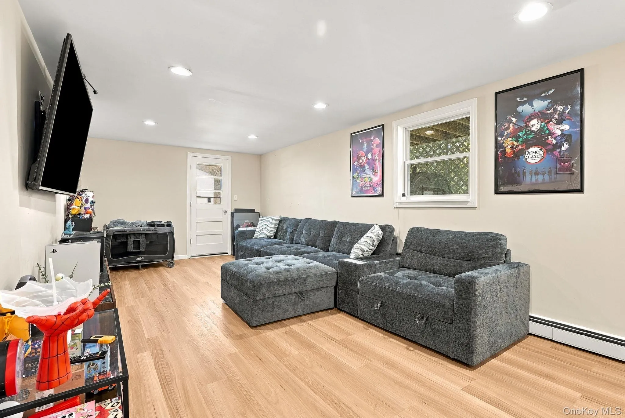 Neutral interior space featuring wood-finish flooring, recessed lighting, and a single-light glass panel entry door Neutral interior space featuring wood-finish flooring, recessed lighting, and a single-light glass panel entry door