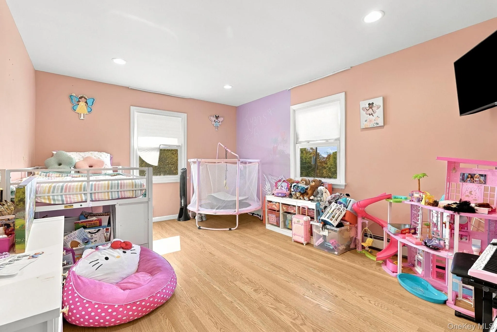 Spacious room featuring wood-finish flooring, recessed lighting, and dual windows Spacious room featuring wood-finish flooring, recessed lighting, and dual windows