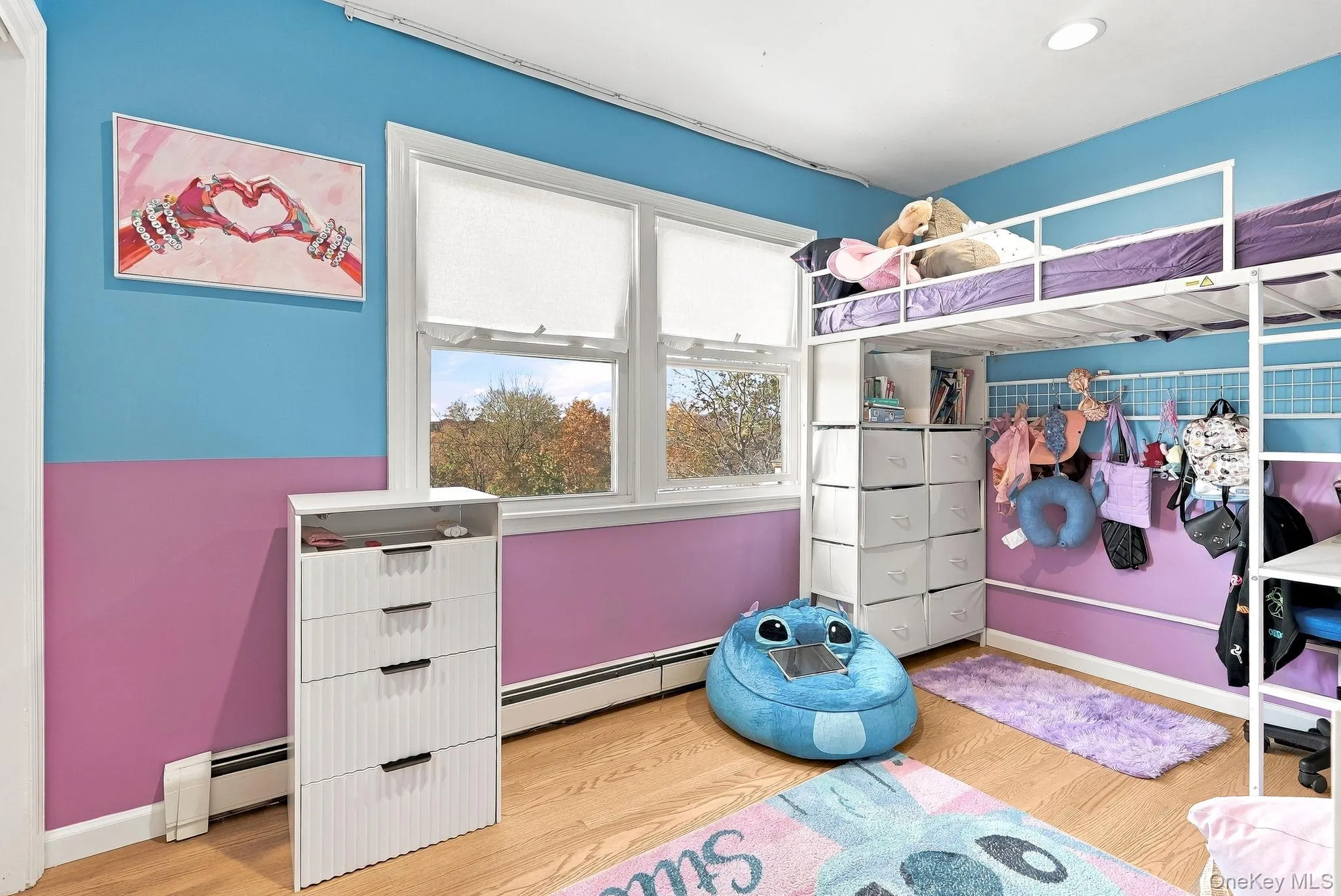 Room featuring wood-finish flooring, dual-pane windows, and recessed ceiling lighting Room featuring wood-finish flooring, dual-pane windows, and recessed ceiling lighting