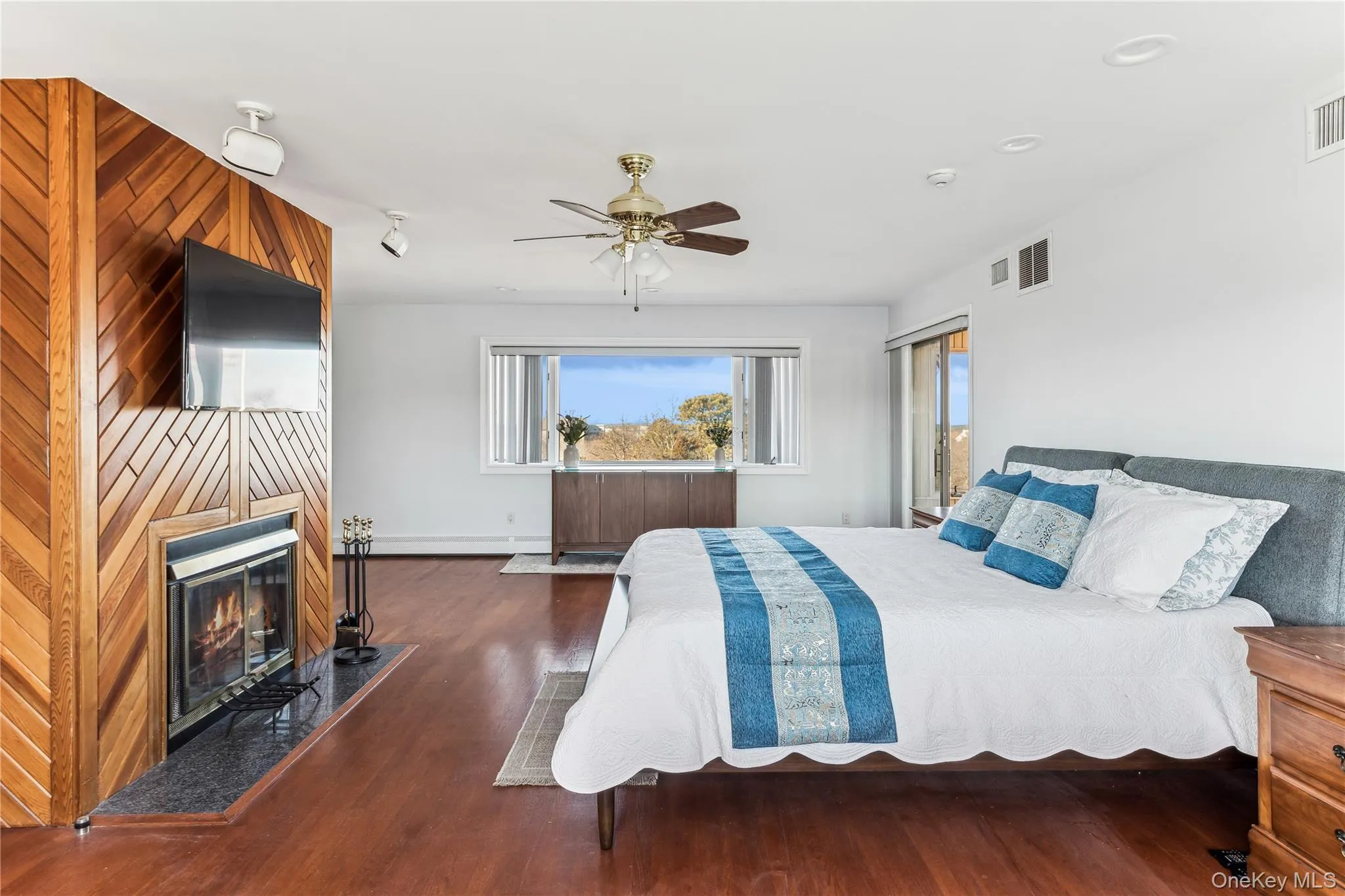 Bedroom featuring dark hardwood / wood-style floors and ceiling fan Bedroom featuring dark hardwood / wood-style floors and ceiling fan