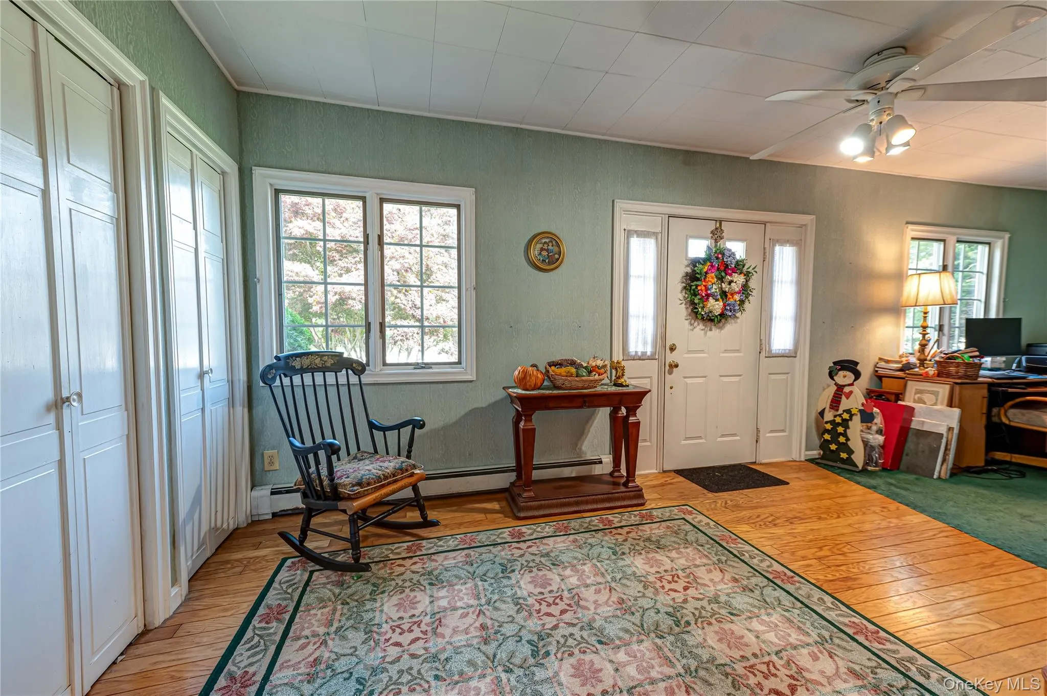 Entrance foyer/sitting area with large windows for plenty of natural light, closets and wood floors. Entrance foyer/sitting area with large windows for plenty of natural light, closets and wood floors.