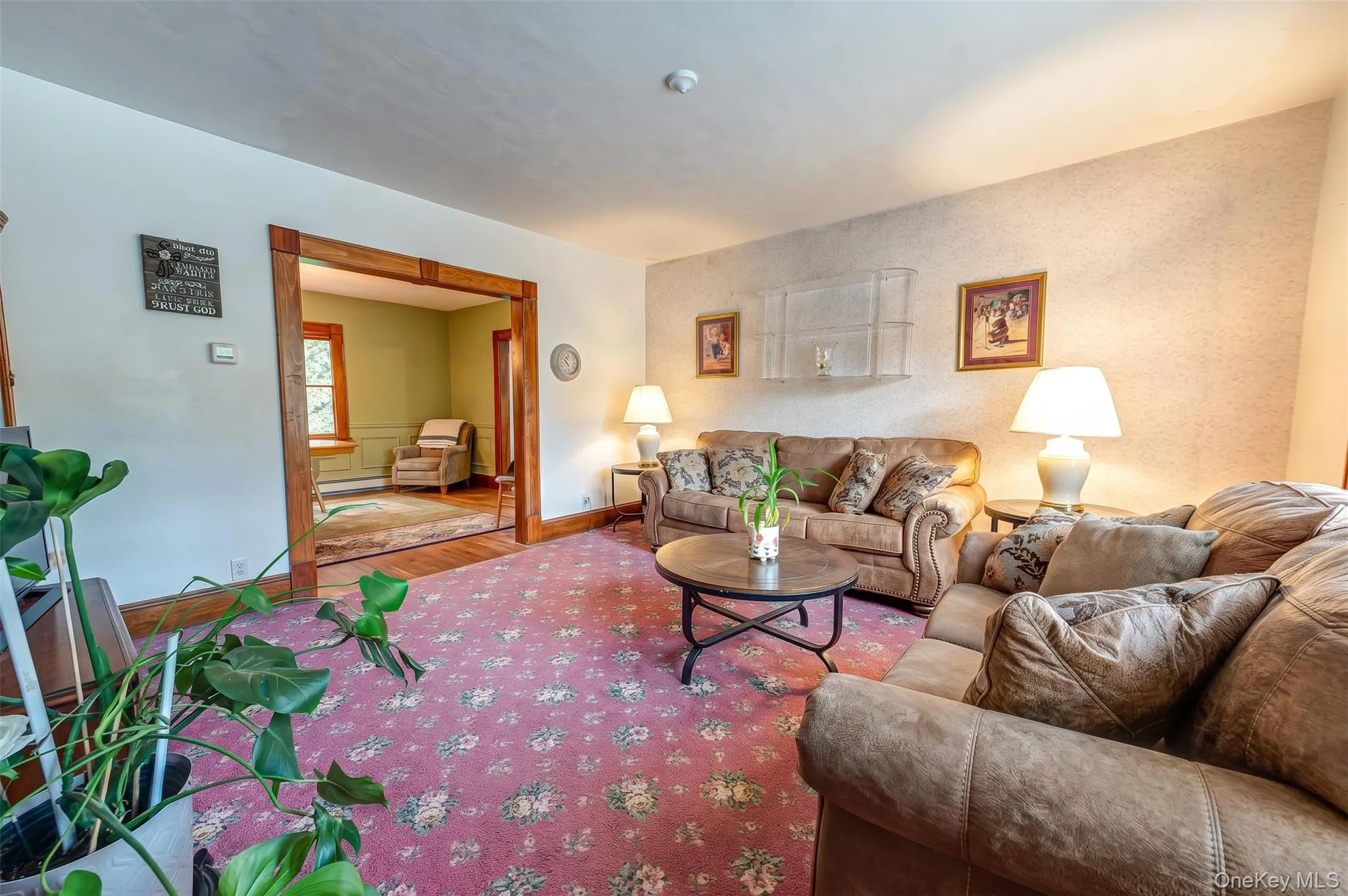 Large living room featuring natural wood molding, hardwood floors. Large living room featuring natural wood molding, hardwood floors.