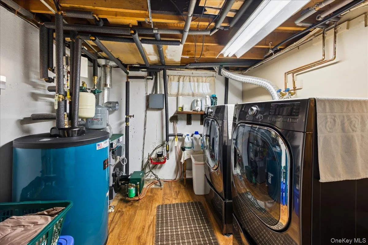 Laundry Room in Basement with Peerless Oil Burner & Hot water tank updated in 2022. Laundry Room in Basement with Peerless Oil Burner & Hot water tank updated in 2022.