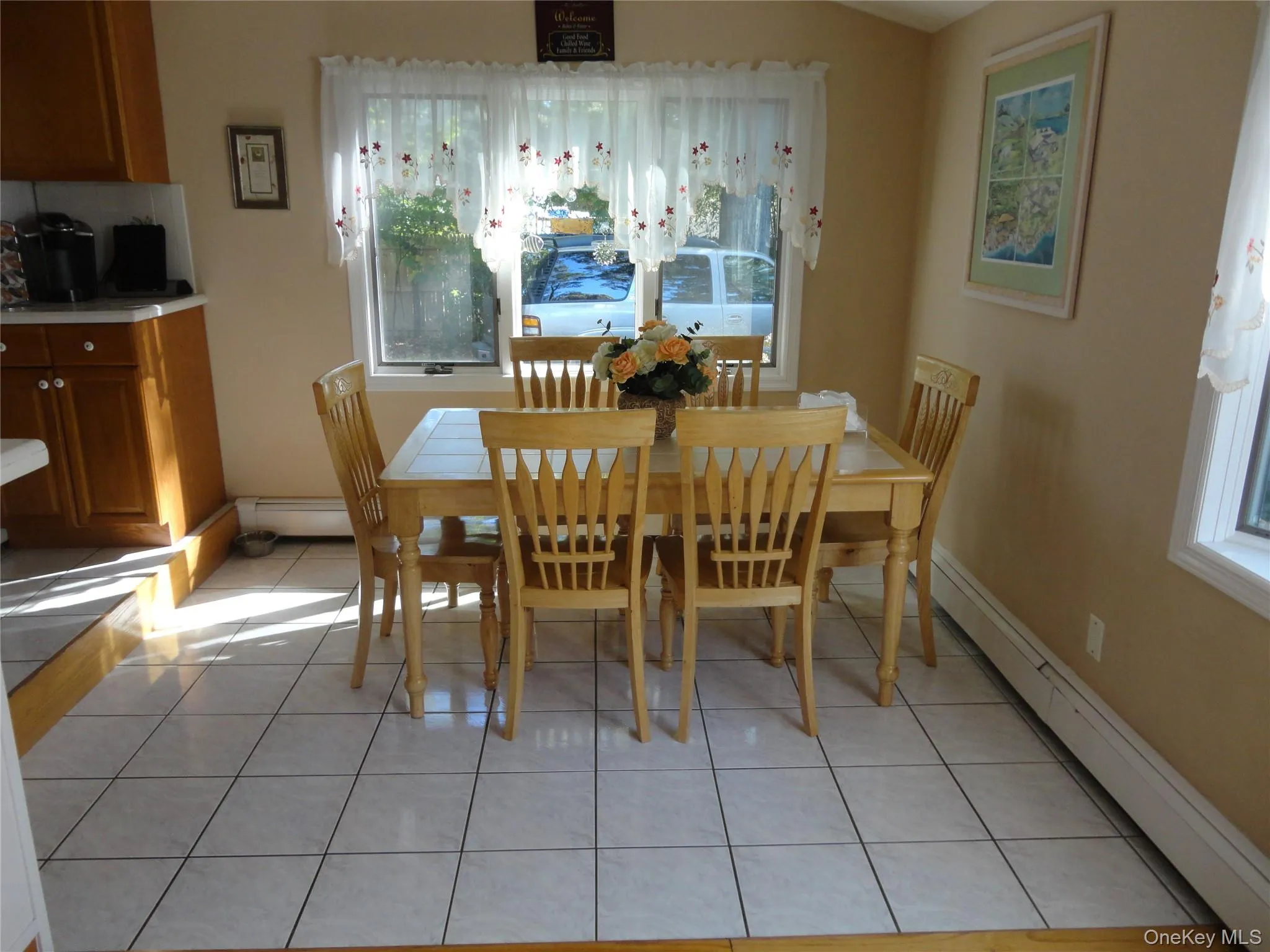 Dining area featuring ceramic tile flooring, built-in wooden cabinetry, and large windows Dining area featuring ceramic tile flooring, built-in wooden cabinetry, and large windows