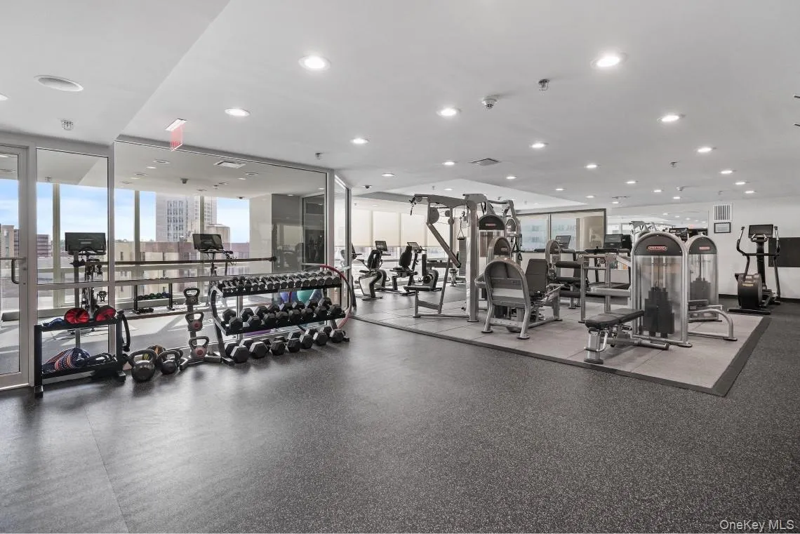 Exercise room featuring expansive windows and recessed lighting Exercise room featuring expansive windows and recessed lighting