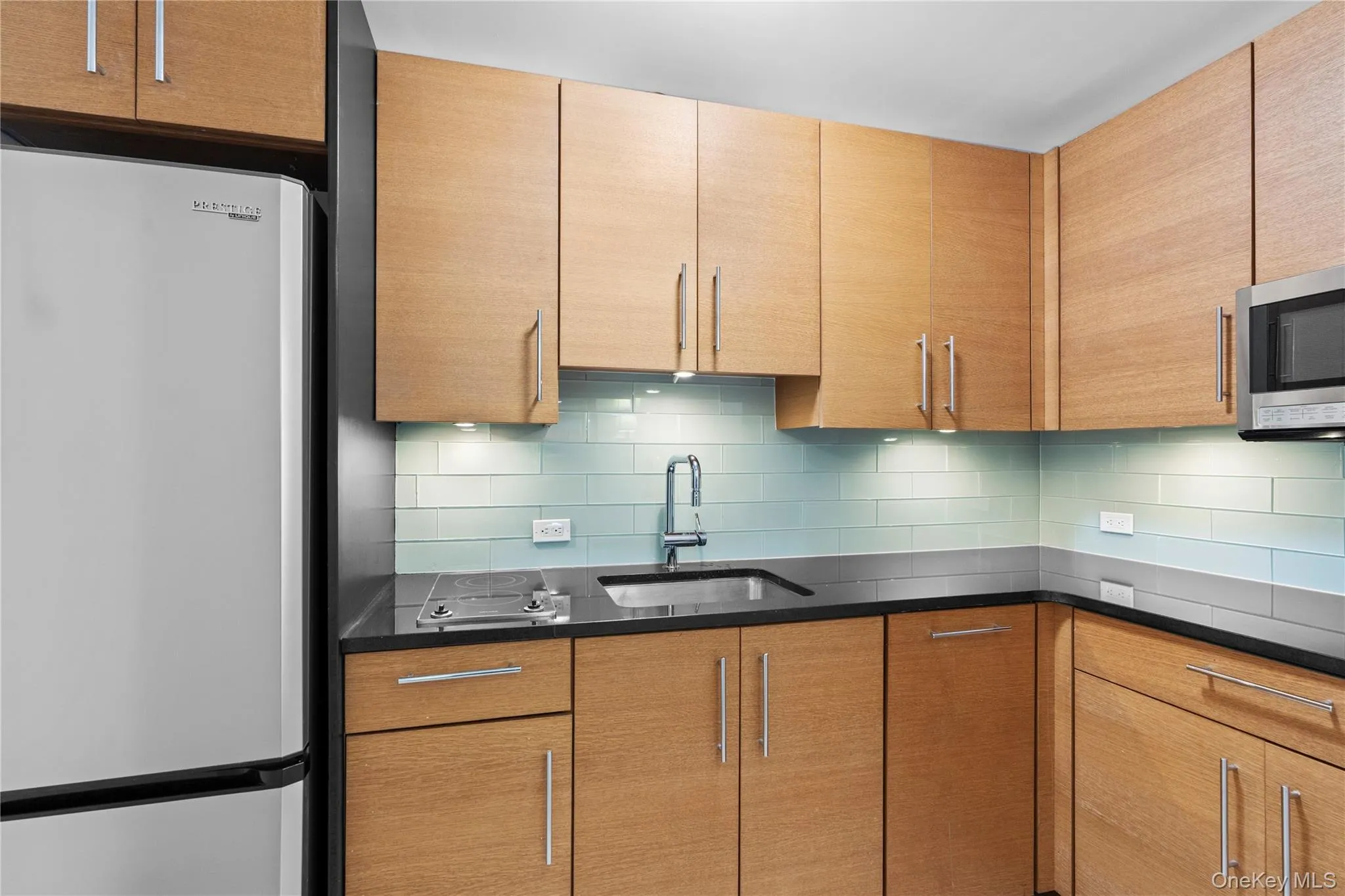 Kitchen featuring appliances with stainless steel finishes, a sink, and tasteful backsplash Kitchen featuring appliances with stainless steel finishes, a sink, and tasteful backsplash
