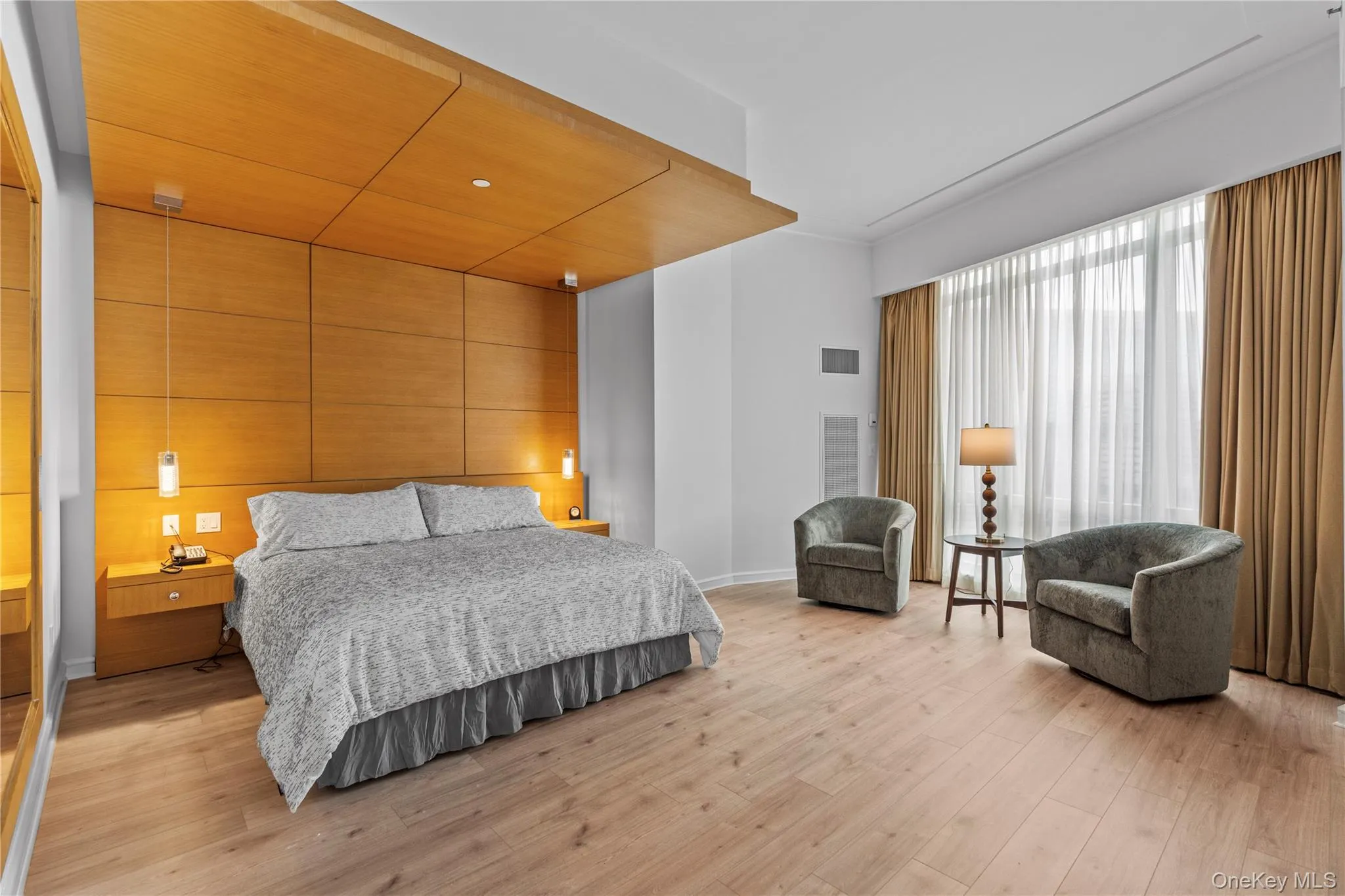 Bedroom with light wood-style floors, visible vents, and baseboards Bedroom with light wood-style floors, visible vents, and baseboards
