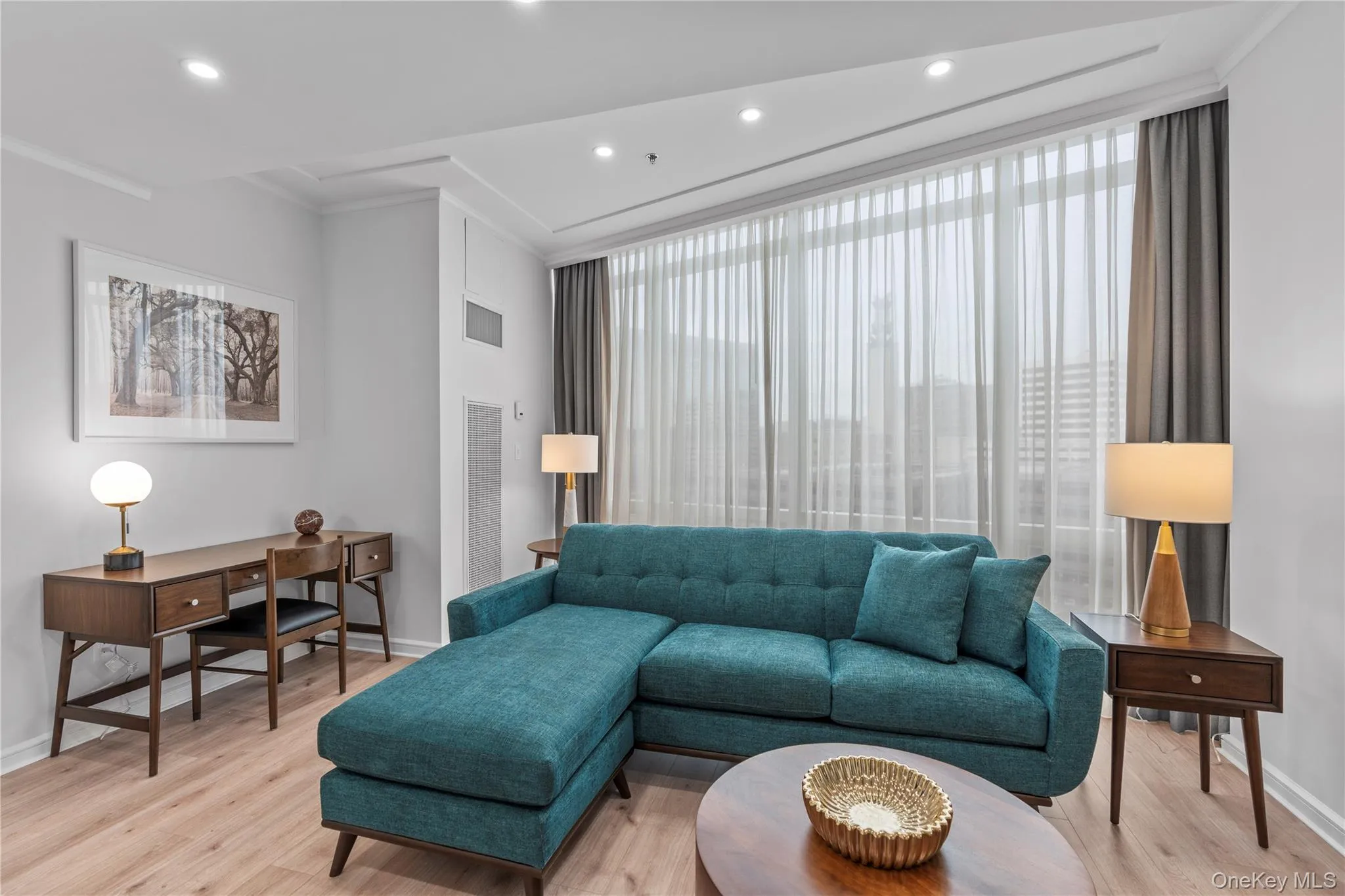 Living room featuring light wood-style floors, baseboards, visible vents, and recessed lighting Living room featuring light wood-style floors, baseboards, visible vents, and recessed lighting