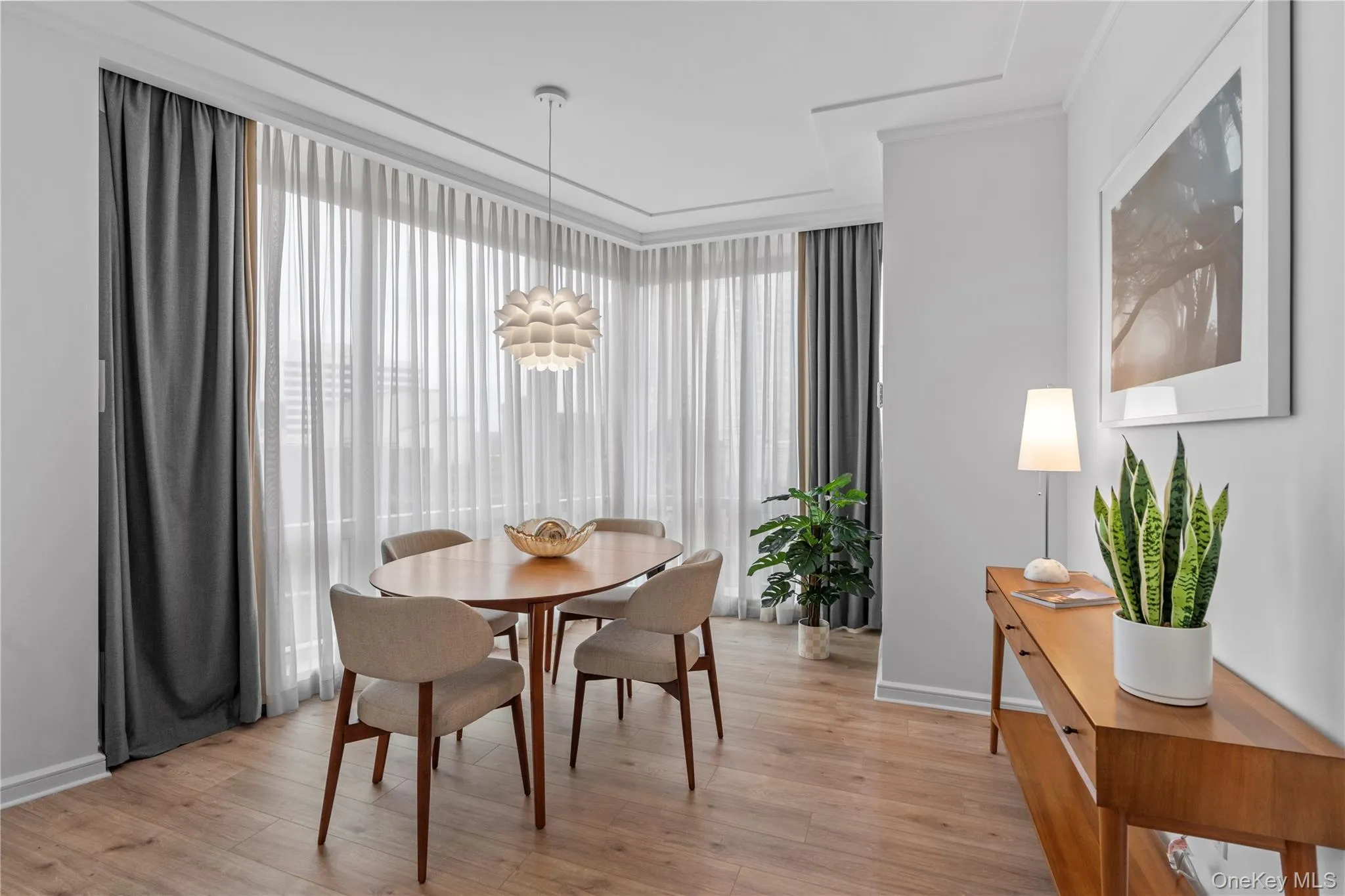 Dining space with light wood finished floors and a wealth of natural light Dining space with light wood finished floors and a wealth of natural light