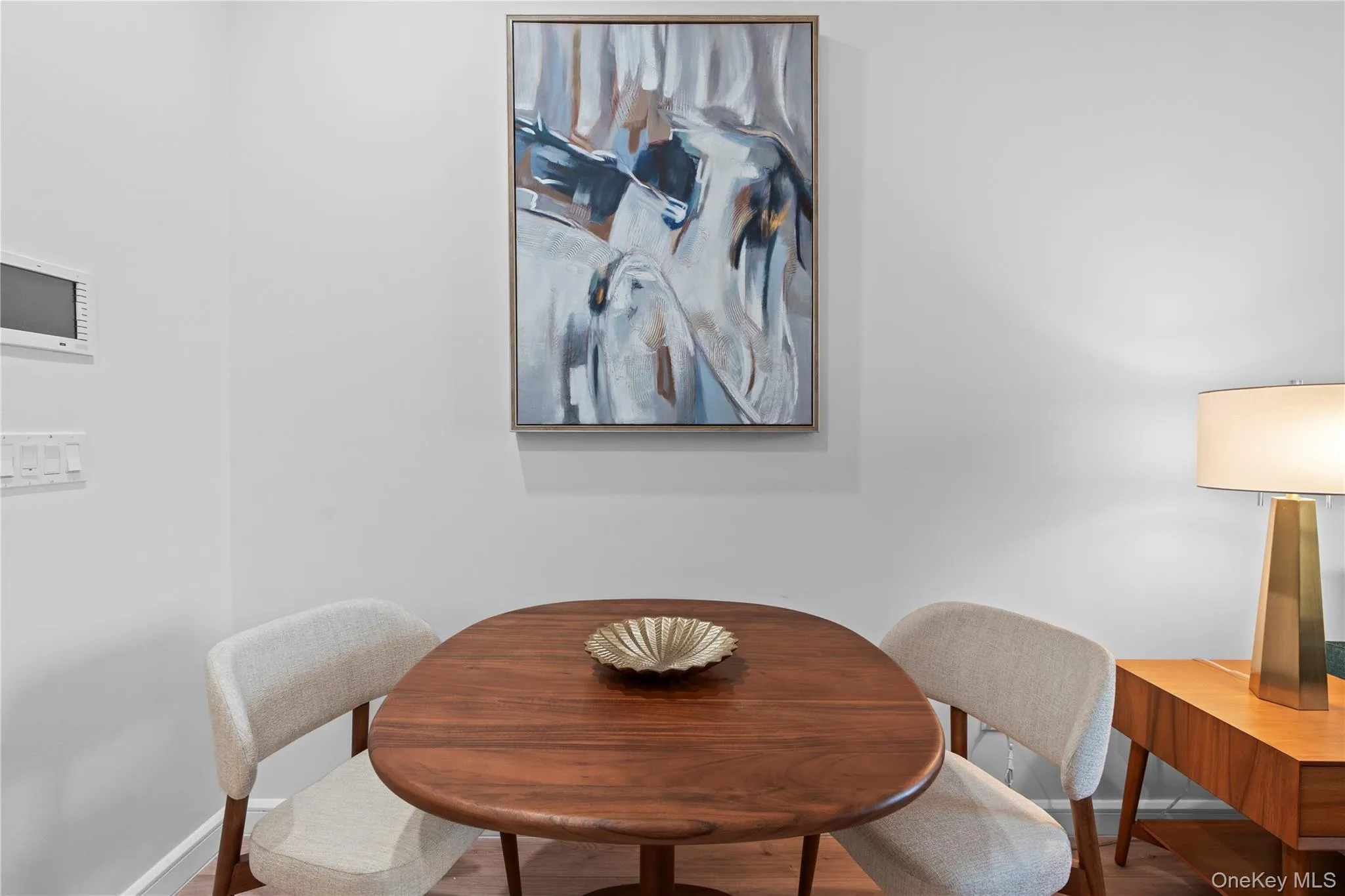 Dining space with baseboards and wood finished floors Dining space with baseboards and wood finished floors