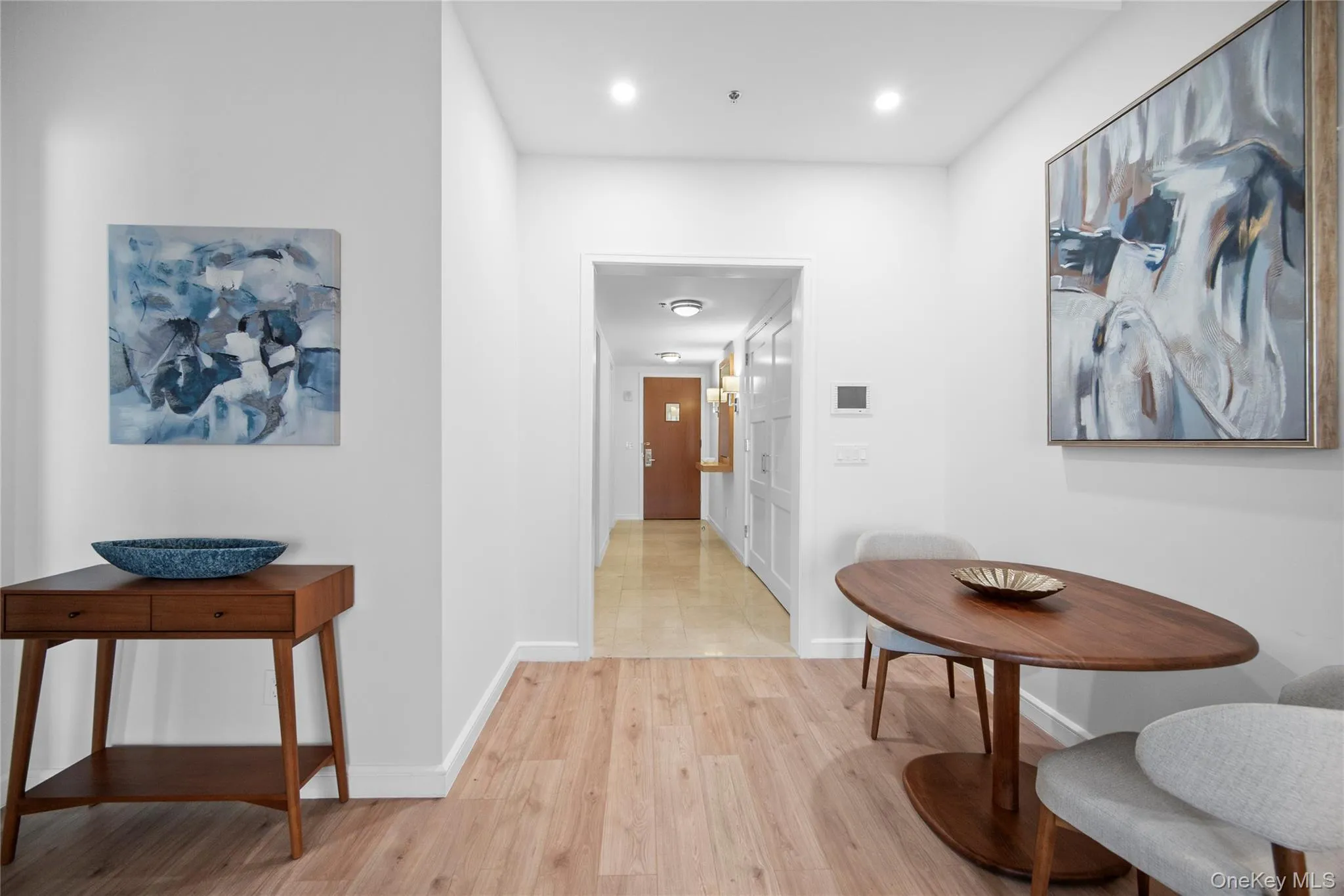 Hall featuring light wood finished floors, baseboards, and recessed lighting Hall featuring light wood finished floors, baseboards, and recessed lighting