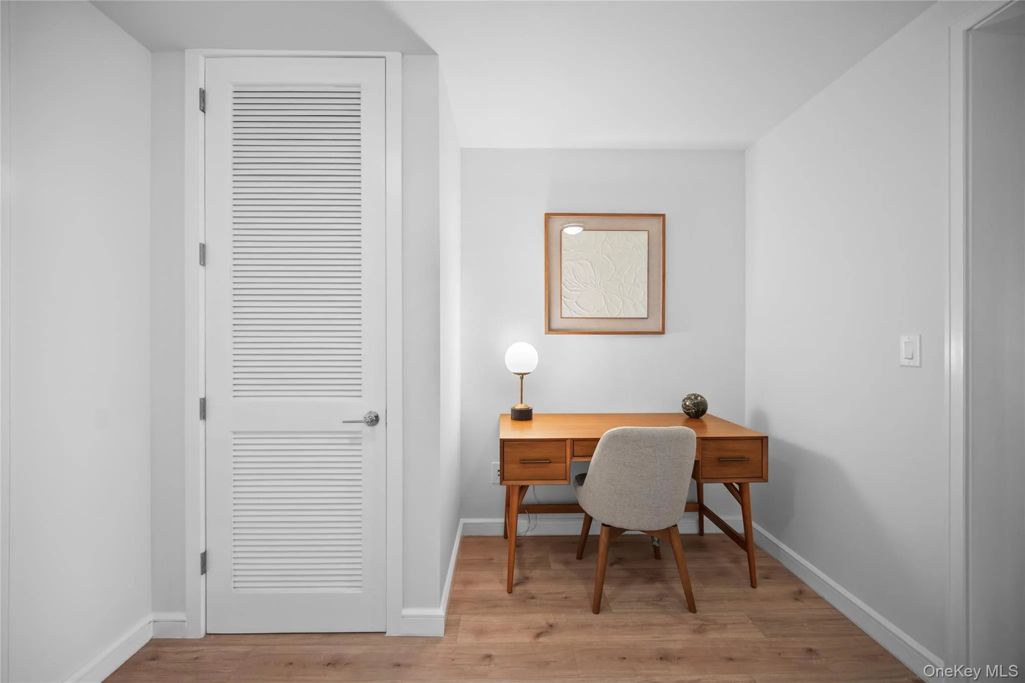 Home office with wood finished floors and baseboards Home office with wood finished floors and baseboards