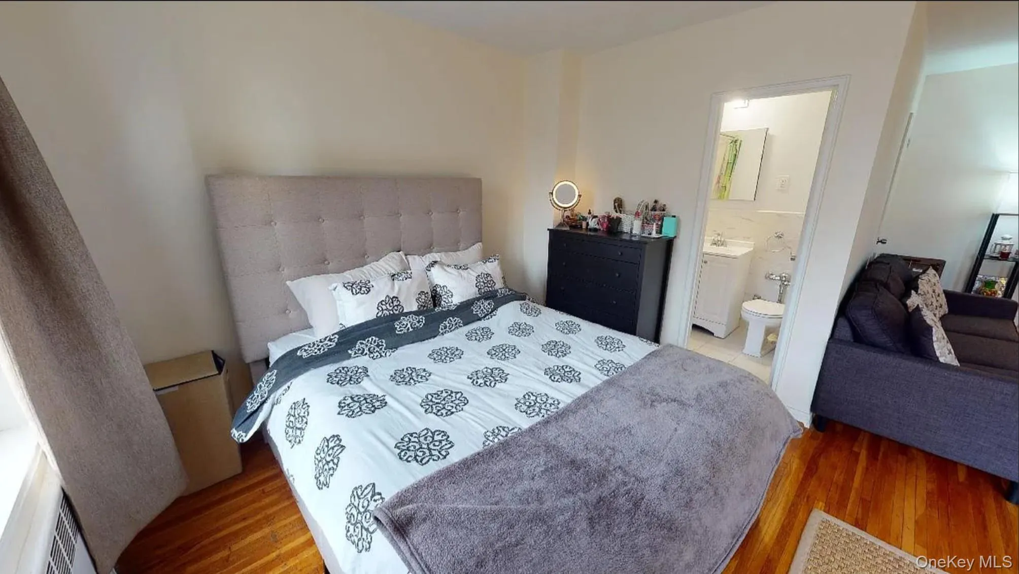 Hardwood flooring throughout featuring a neutral paint palette and an en-suite bathroom with a vanity and integrated sink Hardwood flooring throughout featuring a neutral paint palette and an en-suite bathroom with a vanity and integrated sink