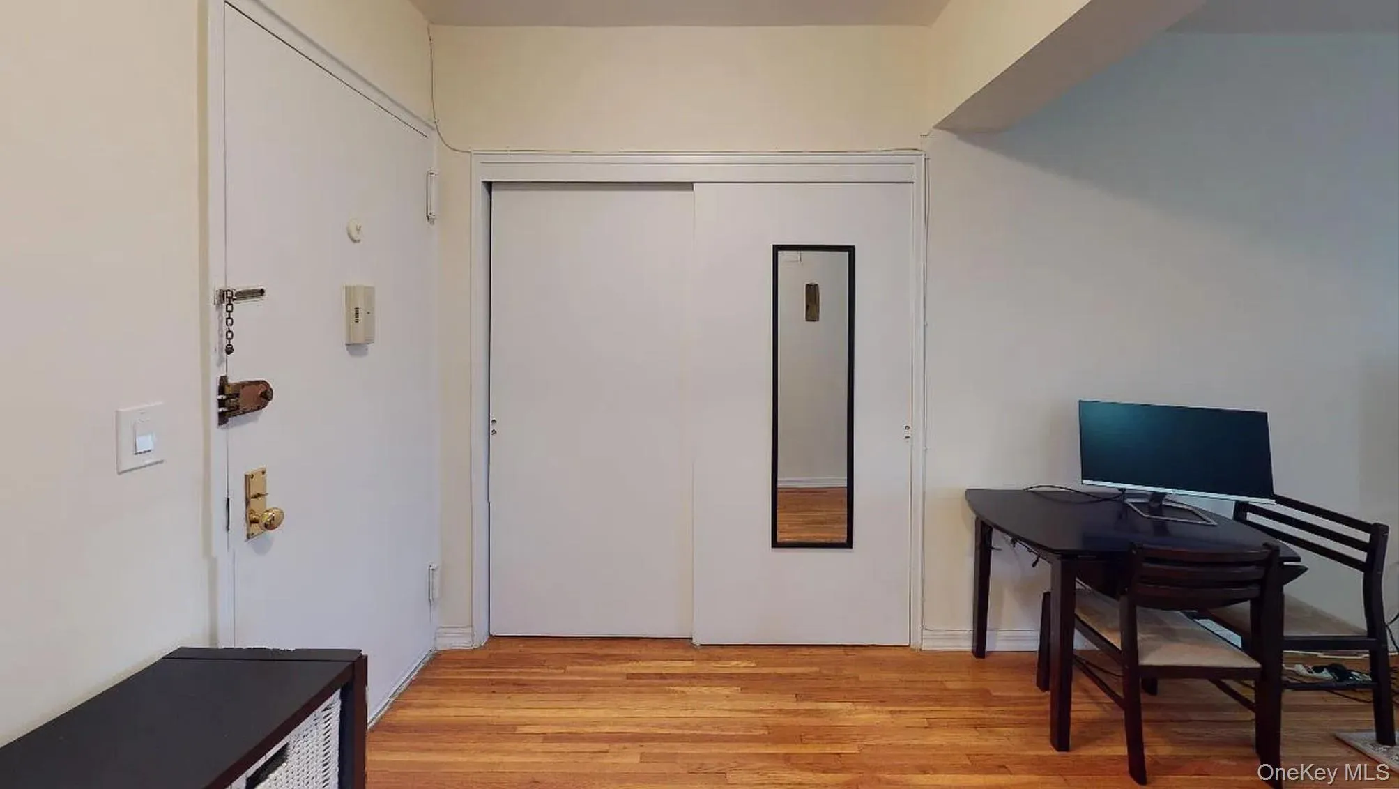 Hardwood flooring, sliding closet doors with an integrated full-length mirror, and solid core entry door with deadbolt hardware Hardwood flooring, sliding closet doors with an integrated full-length mirror, and solid core entry door with deadbolt hardware