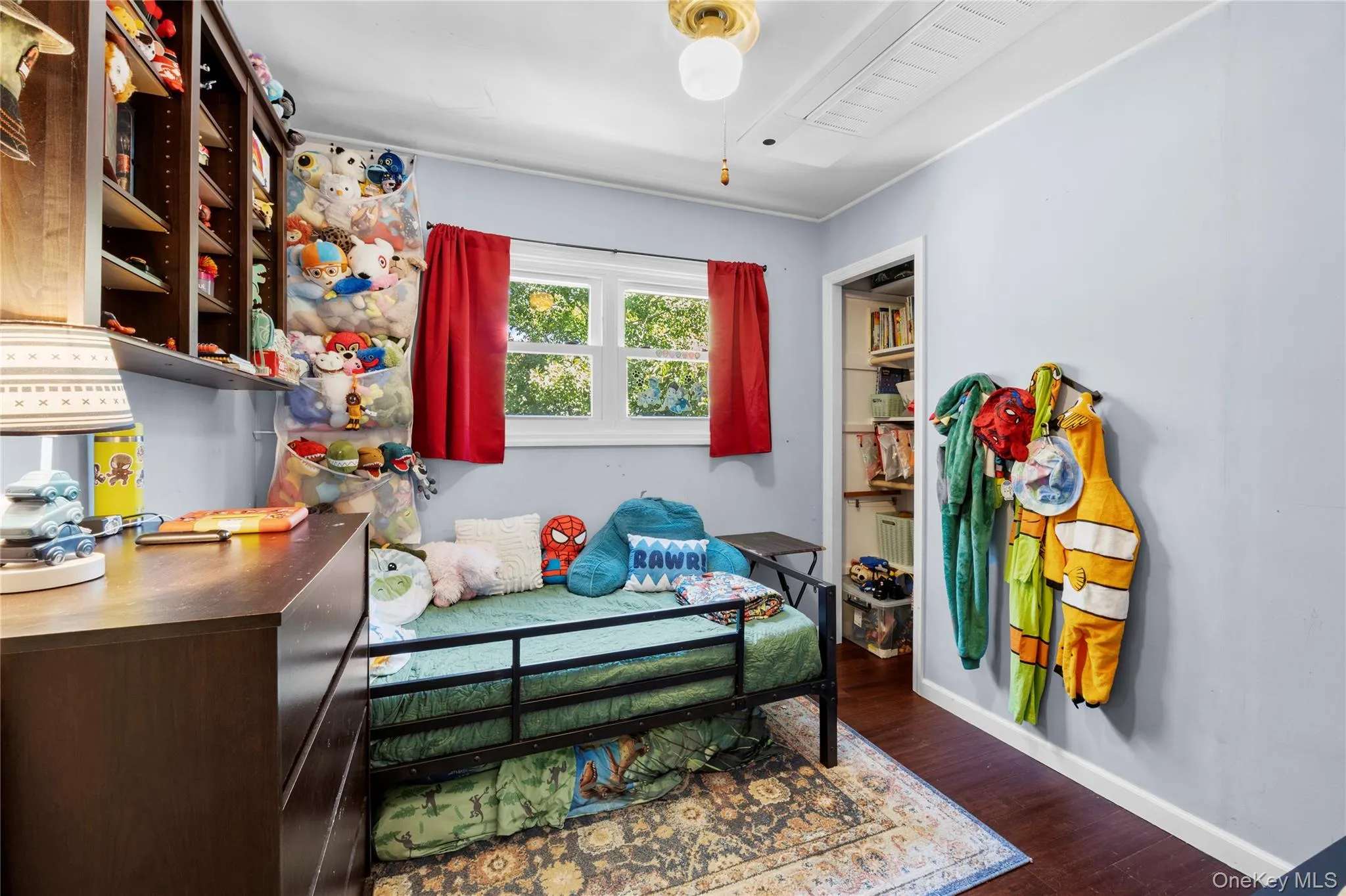 Wood-finish flooring, built-in wall shelving, and a reach-in closet with integrated storage (Decluttered Edit) Wood-finish flooring, built-in wall shelving, and a reach-in closet with integrated storage (Decluttered Edit)