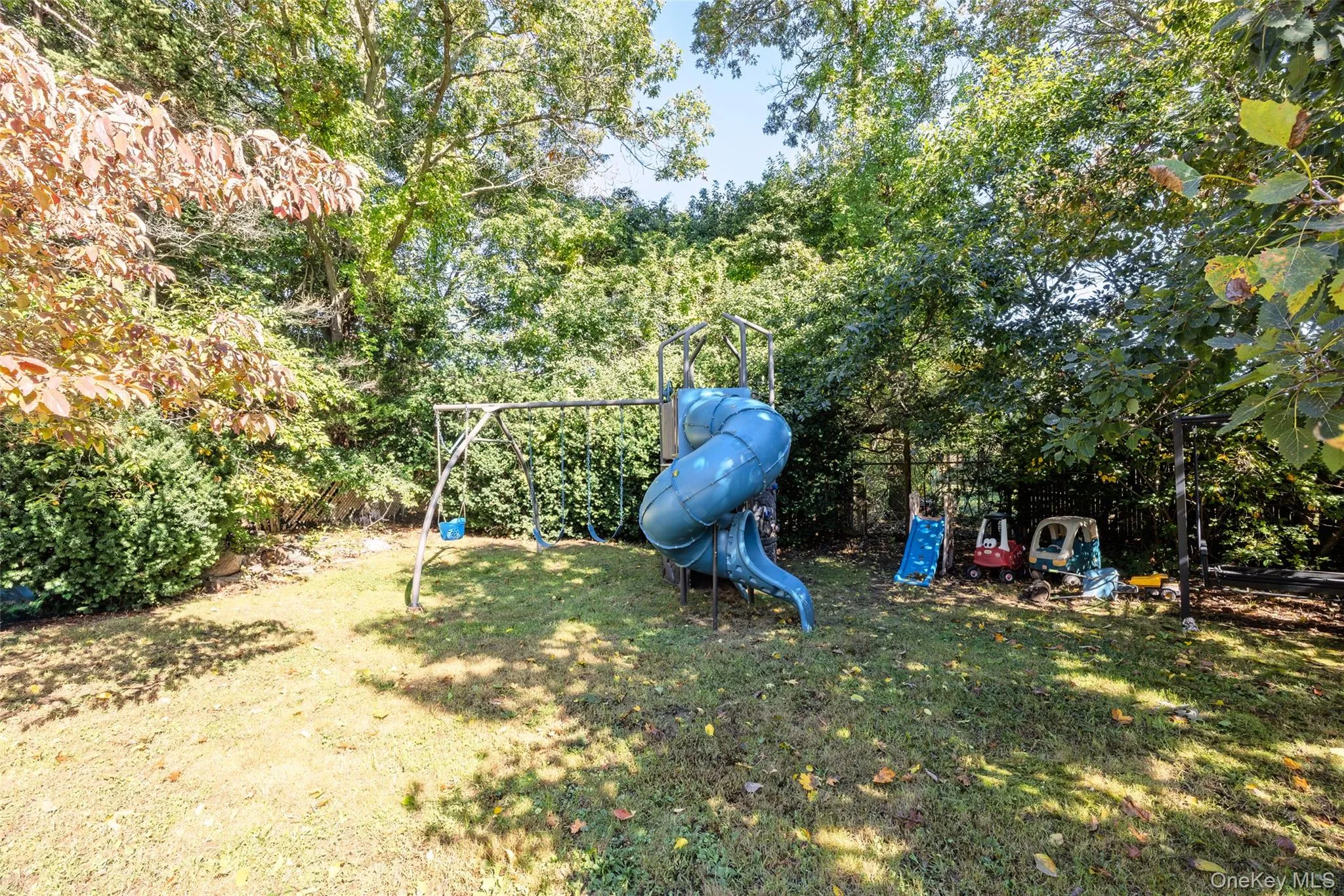 Expansive backyard featuring mature trees and established greenery Expansive backyard featuring mature trees and established greenery