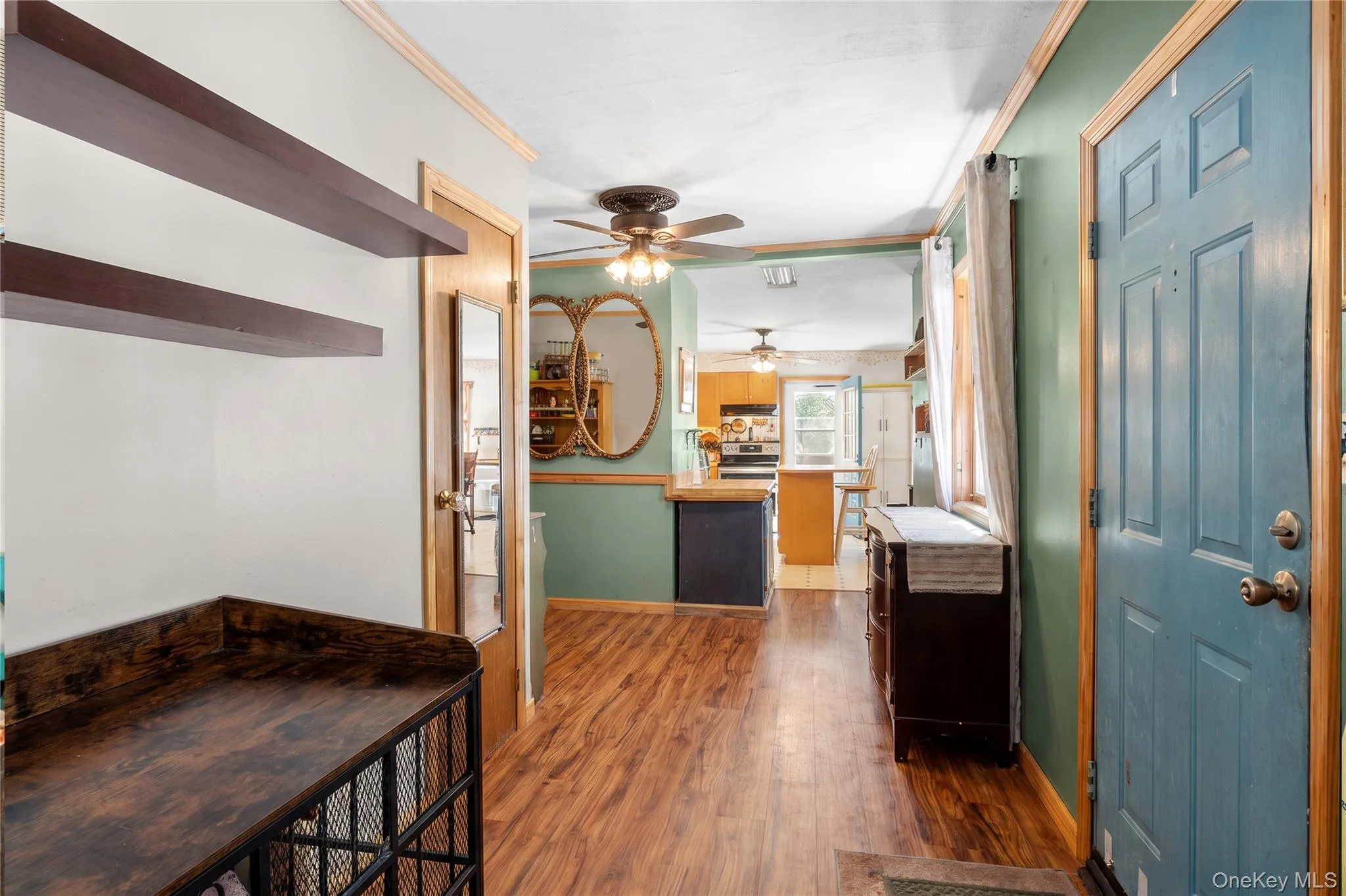 Wood-finish flooring, built-in wall shelving, chair rail molding, and ceiling fans Wood-finish flooring, built-in wall shelving, chair rail molding, and ceiling fans