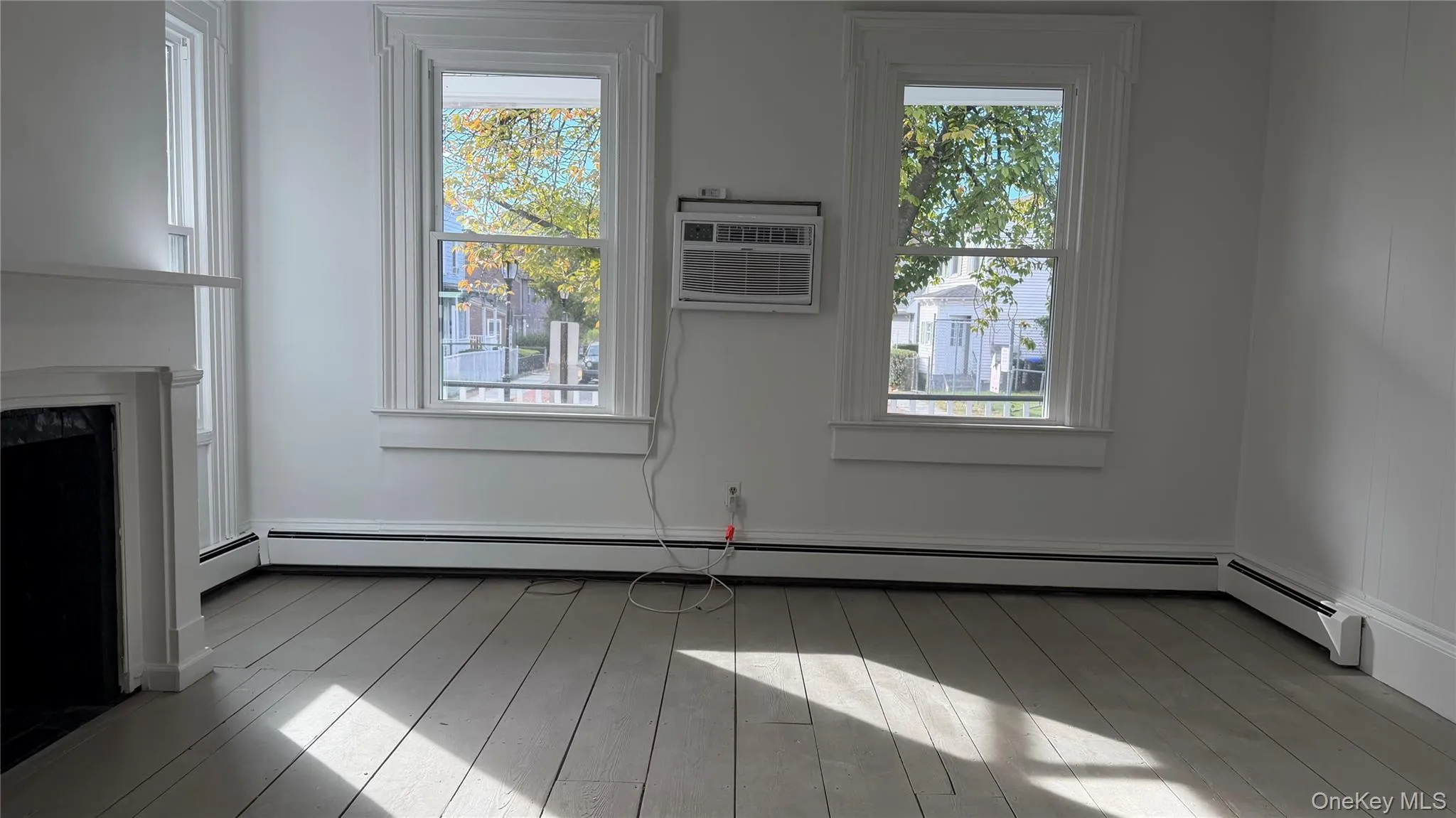 Large Master Bedroom with large windows and hardwood floors Large Master Bedroom with large windows and hardwood floors