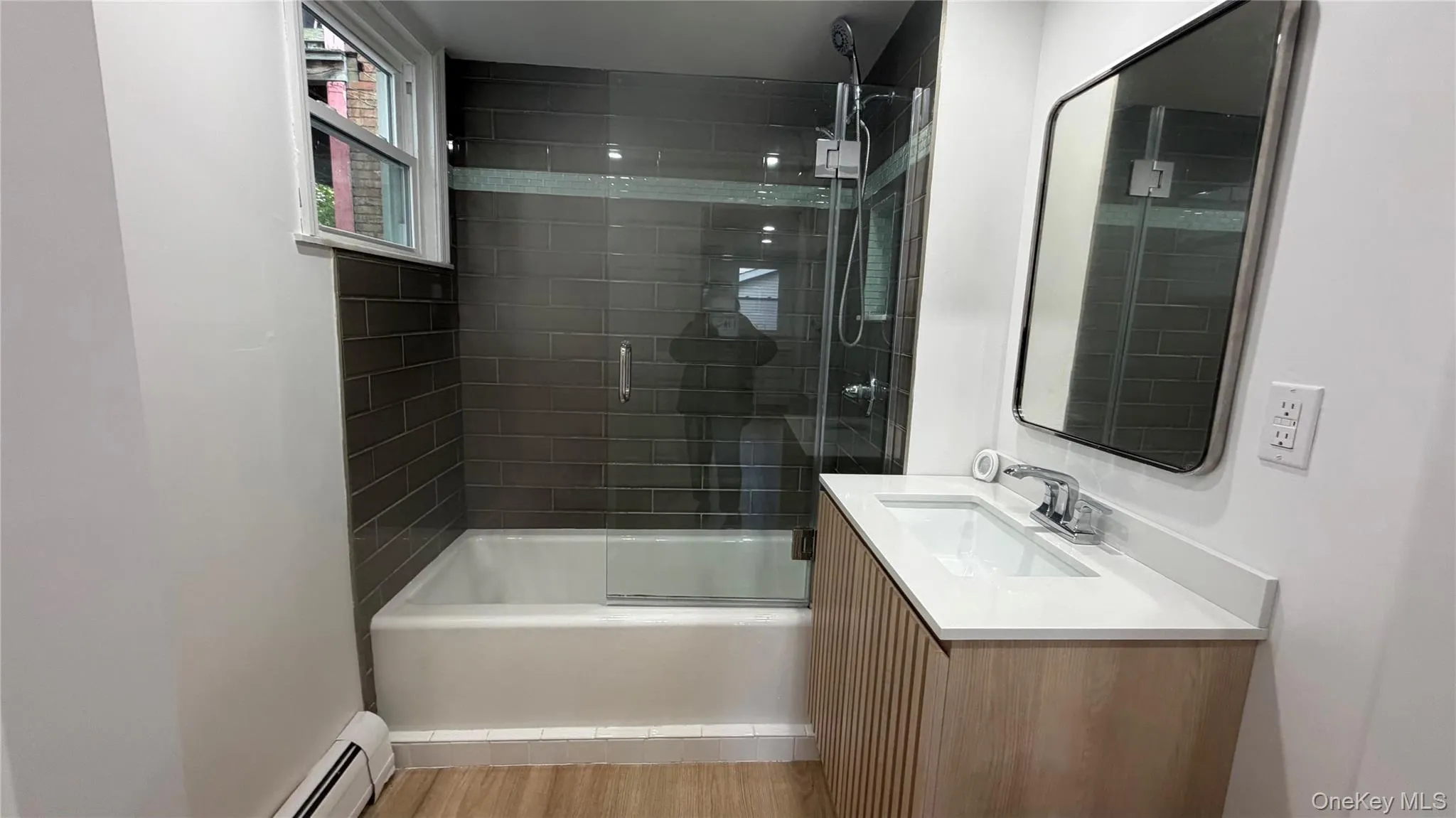 Bathroom has dark updated tiles Bathroom has dark updated tiles