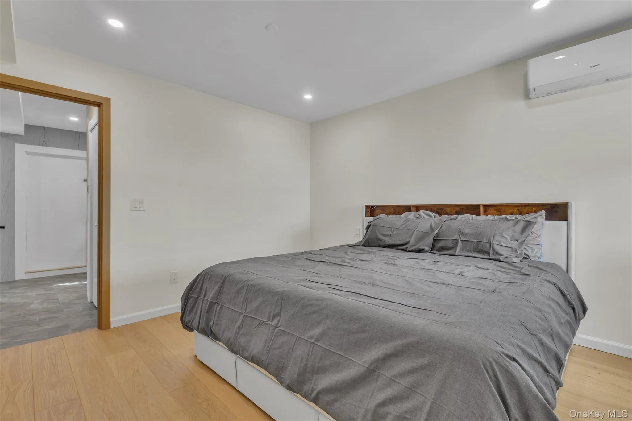 Wood-finish flooring, recessed lighting, and wall-mounted climate control unit Wood-finish flooring, recessed lighting, and wall-mounted climate control unit