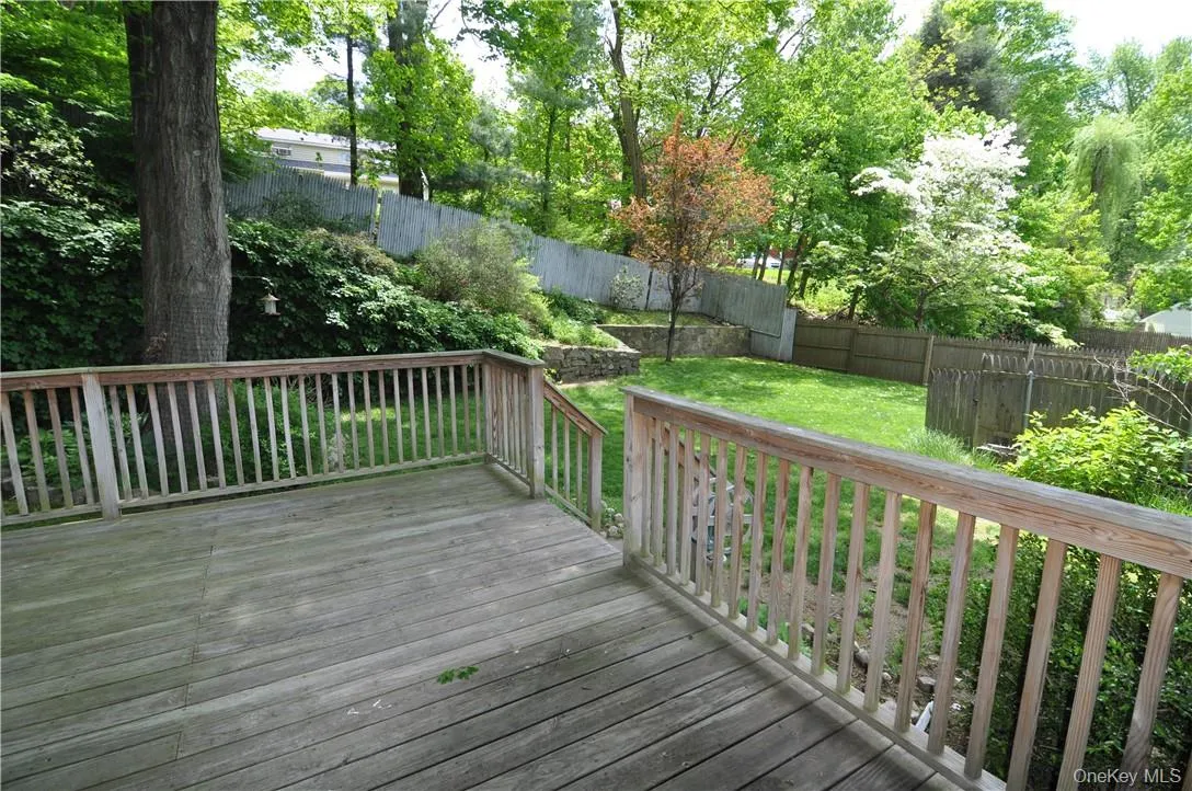 Wooden deck featuring a lawn Wooden deck featuring a lawn