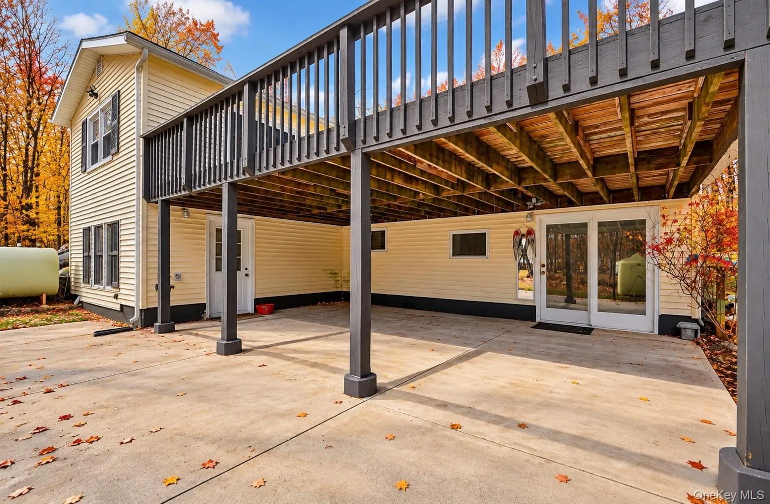 Large patio off of downstairs kitchen, perfect for entertaining.*This photo has been seasonally digitally enhanced. Property features remain unchanged. Large patio off of downstairs kitchen, perfect for entertaining.*This photo has been seasonally digitally enhanced. Property features remain unchanged.