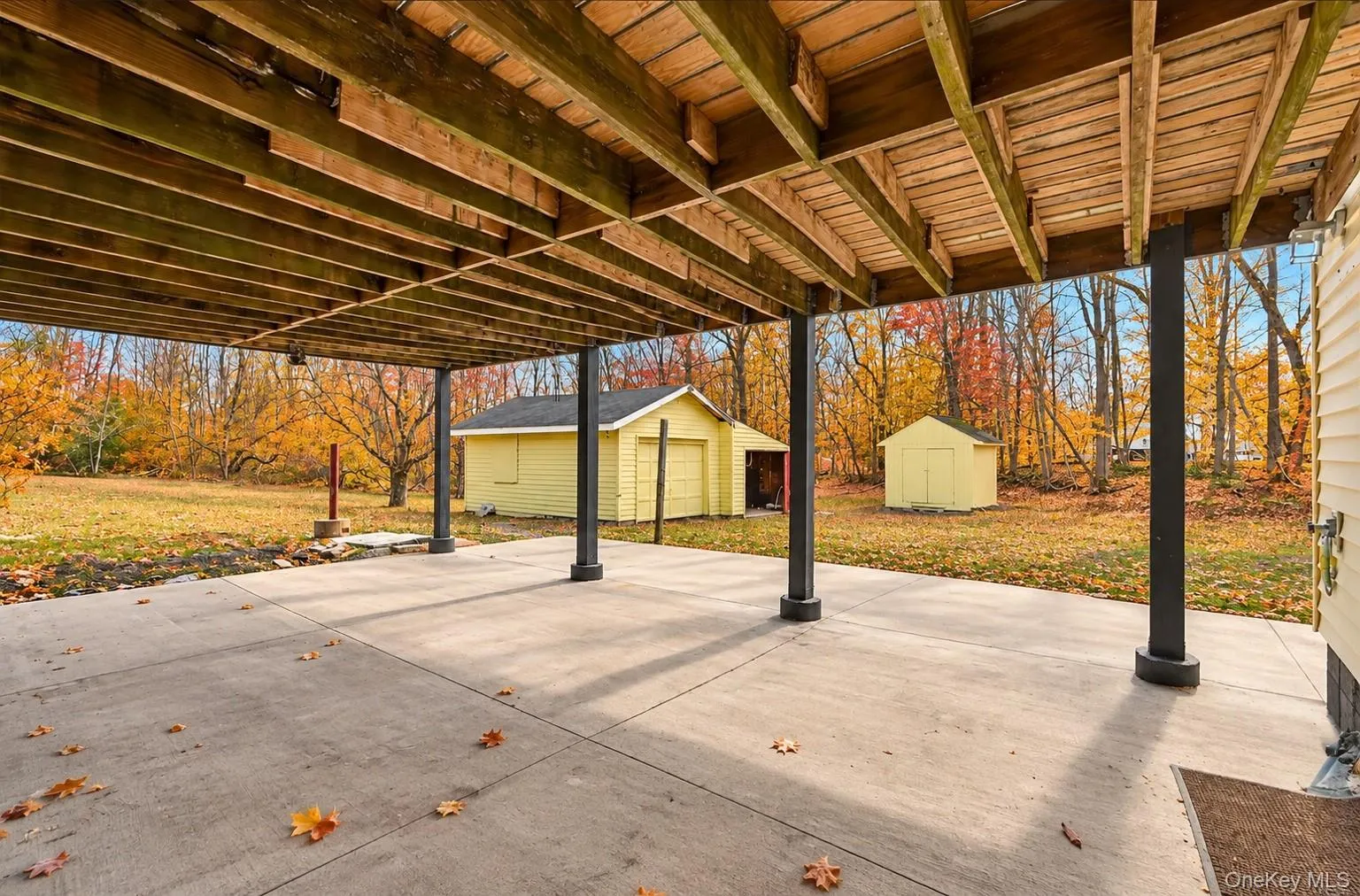 View of 2 car garage and shed*This photo has been seasonally digitally enhanced. Property features remain unchanged. View of 2 car garage and shed*This photo has been seasonally digitally enhanced. Property features remain unchanged.