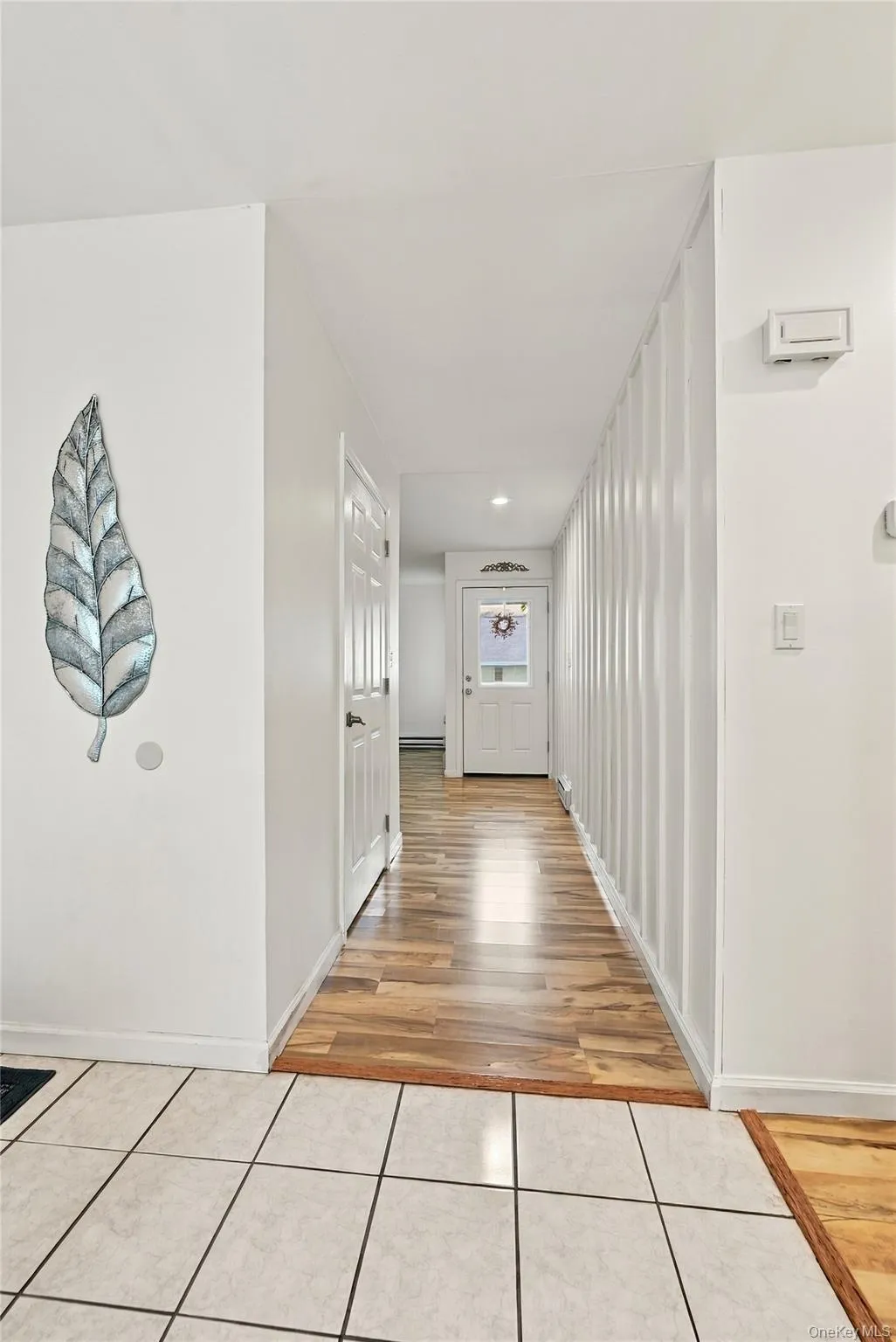 The Entry & Hallway Offers Crisp White Walls & Modern Decor, Stunning Board & Batten/Wainscoted Walls, Recessed Lighting & Laminate Flooring. The Entry & Hallway Offers Crisp White Walls & Modern Decor, Stunning Board & Batten/Wainscoted Walls, Recessed Lighting & Laminate Flooring.