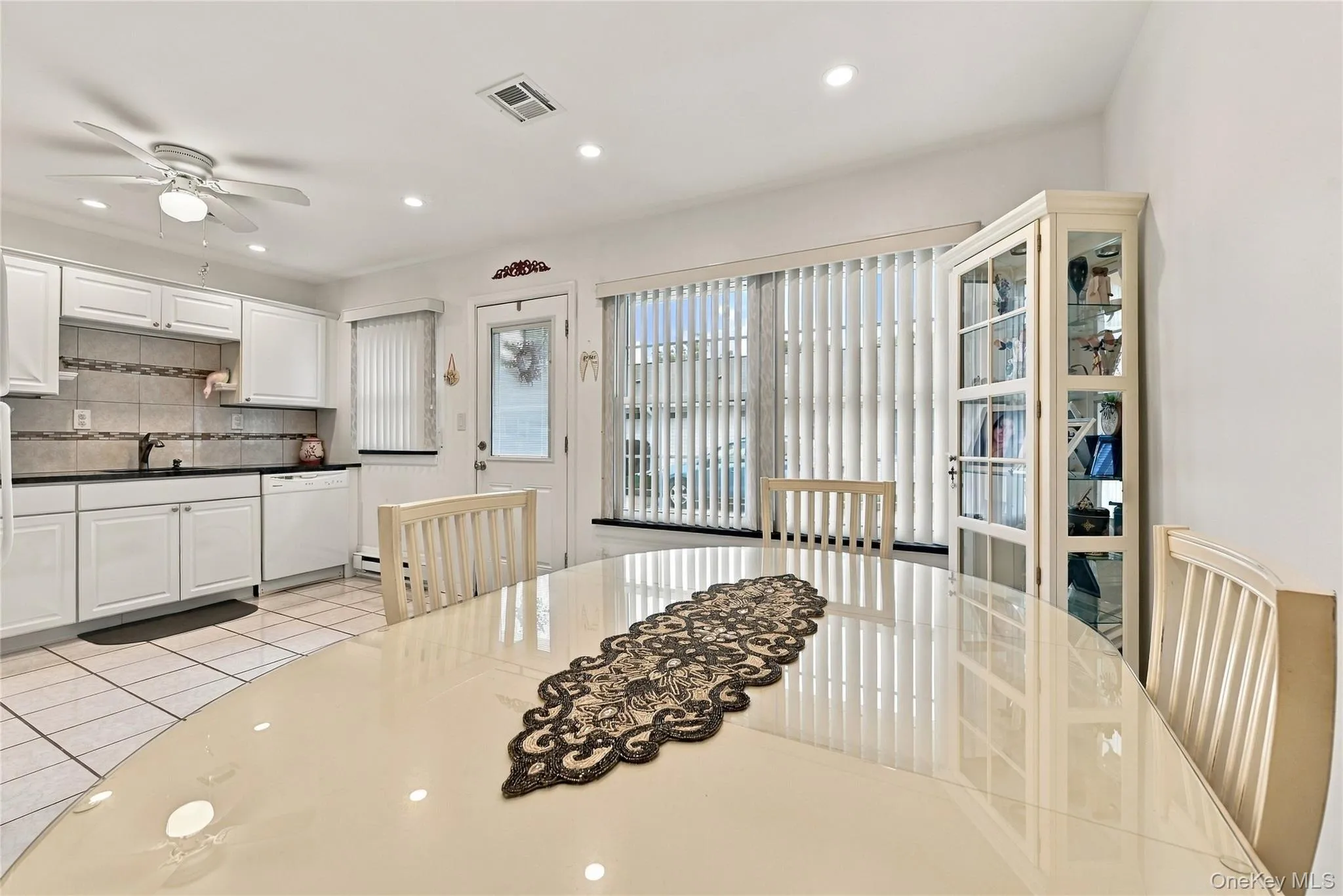 The Stunning, Completely Upgraded Modern Kitchen Offers Walls Of White Raised Panel Cabinetry, Granite Countertops With An Undermount Sink, Tiled Backsplash With Accent Borders, Built In Pantry/Storage, LED Recessed Lighting, Ceiling Fan, Ceramic Tile Floors, Large Separate Dinette Area & Access To The Attached Garage & The Driveway. The Stunning, Completely Upgraded Modern Kitchen Offers Walls Of White Raised Panel Cabinetry, Granite Countertops With An Undermount Sink, Tiled Backsplash With Accent Borders, Built In Pantry/Storage, LED Recessed Lighting, Ceiling Fan, Ceramic Tile Floors, Large Separate Dinette Area & Access To The Attached Garage & The Driveway.