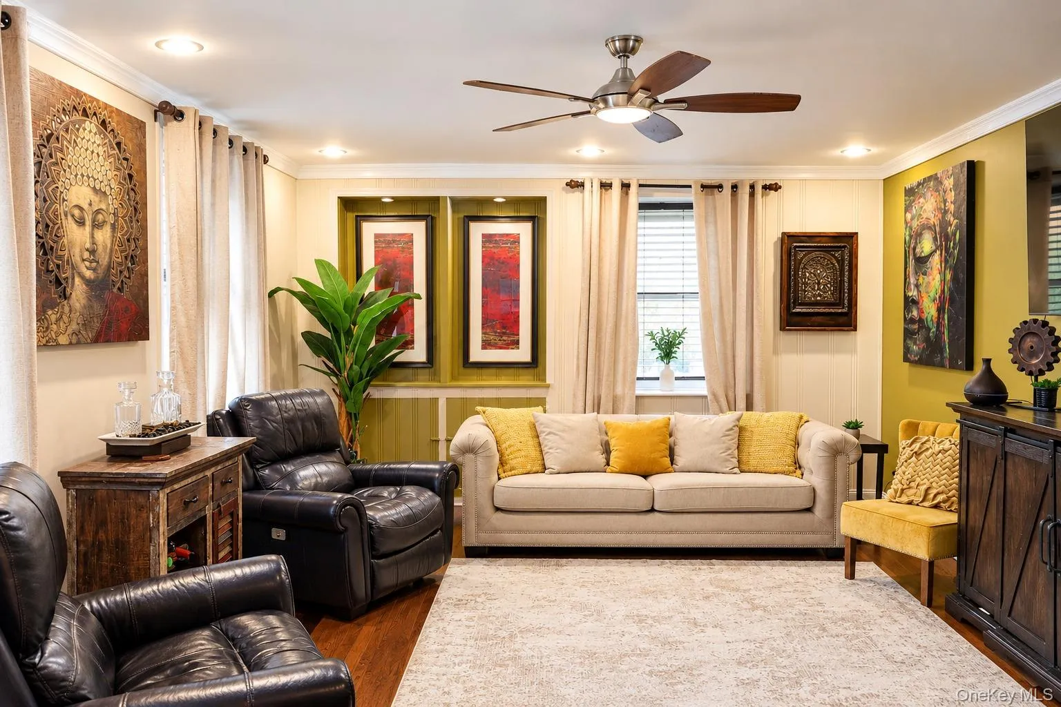 Living area featuring recessed lighting, a modern ceiling fan, built-in recessed shelving, crown molding, and wood-finish flooring Living area featuring recessed lighting, a modern ceiling fan, built-in recessed shelving, crown molding, and wood-finish flooring