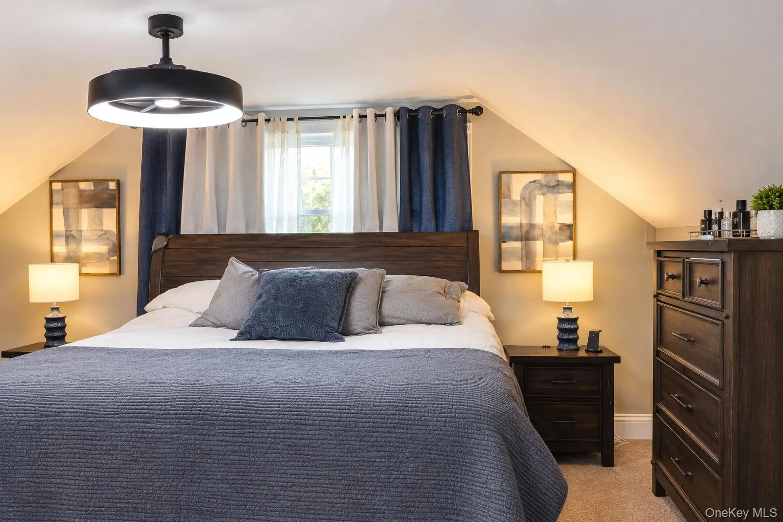 Sloped ceiling with recessed window featuring a black matte finish ceiling fan with integrated LED lighting Sloped ceiling with recessed window featuring a black matte finish ceiling fan with integrated LED lighting
