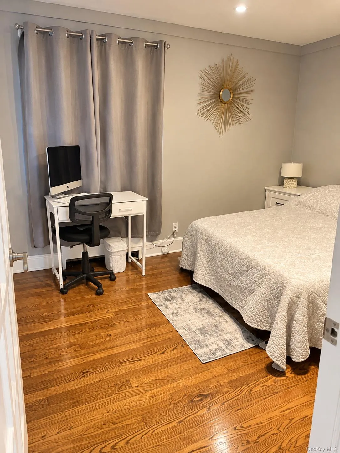 Neutral-toned interior room featuring wood-finish flooring and recessed ceiling lighting Neutral-toned interior room featuring wood-finish flooring and recessed ceiling lighting