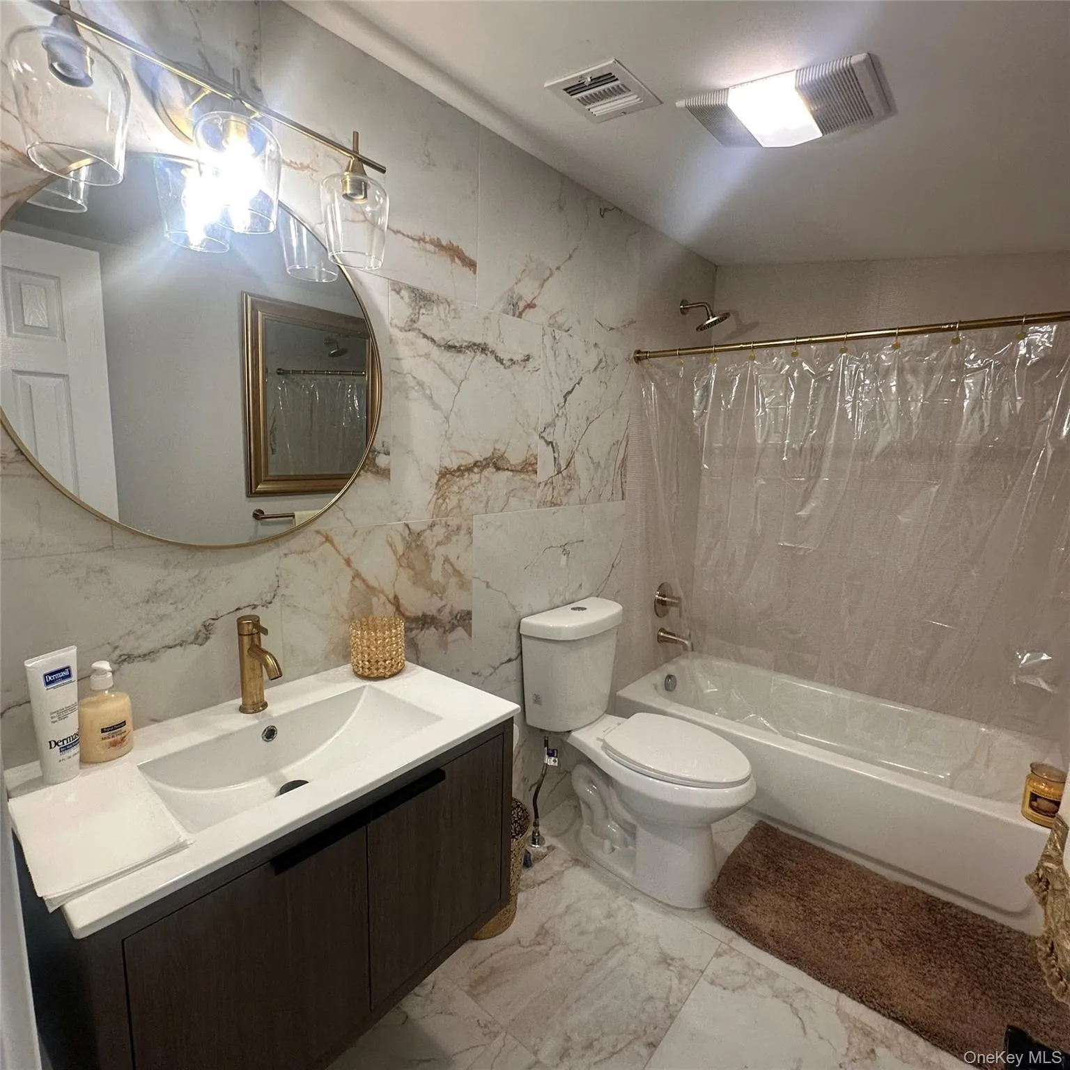 Vinyl flooring and walls. Hanging mirror, exhaust fan, brass fixtures. Vinyl flooring and walls. Hanging mirror, exhaust fan, brass fixtures.
