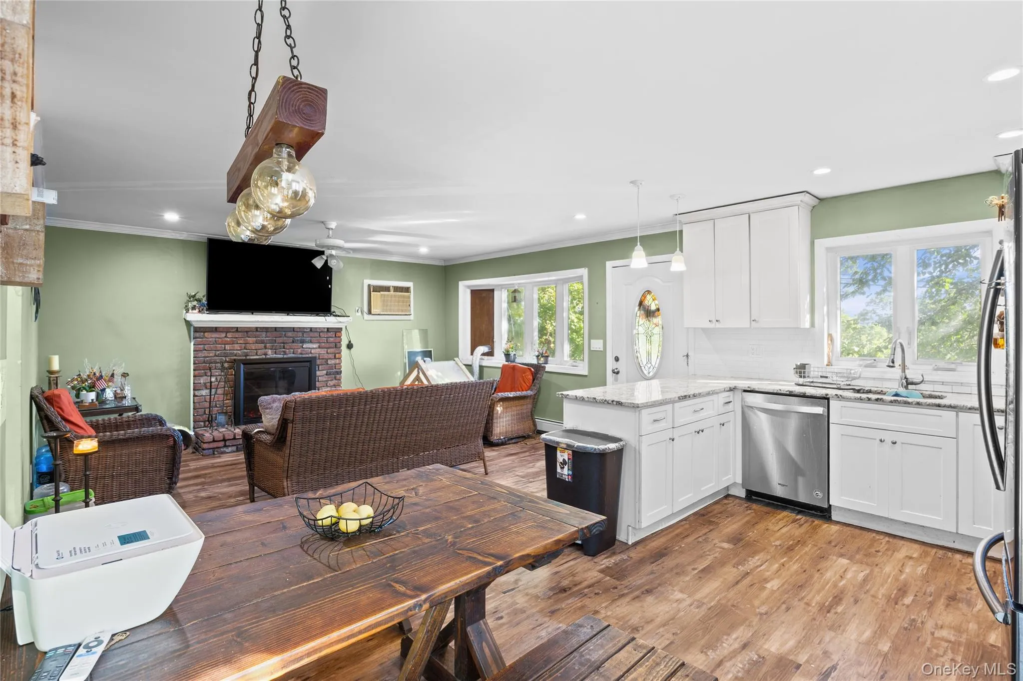 Kitchen featuring white cabinetry, stone countertops, and stainless steel dishwasher Kitchen featuring white cabinetry, stone countertops, and stainless steel dishwasher