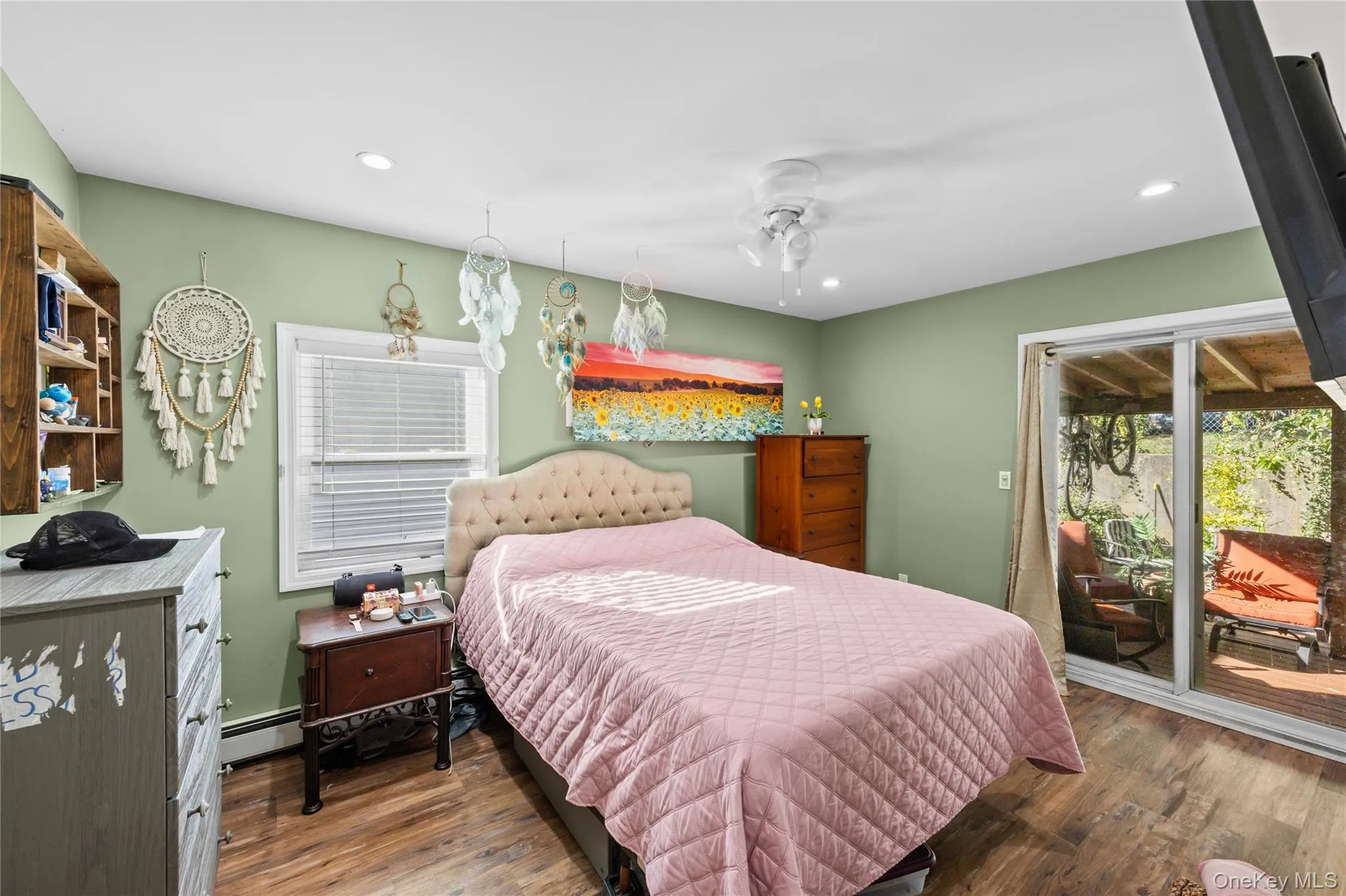 Wood-finish flooring, recessed lighting, ceiling fan with integrated lighting, built-in wall shelving, and sliding glass door Wood-finish flooring, recessed lighting, ceiling fan with integrated lighting, built-in wall shelving, and sliding glass door