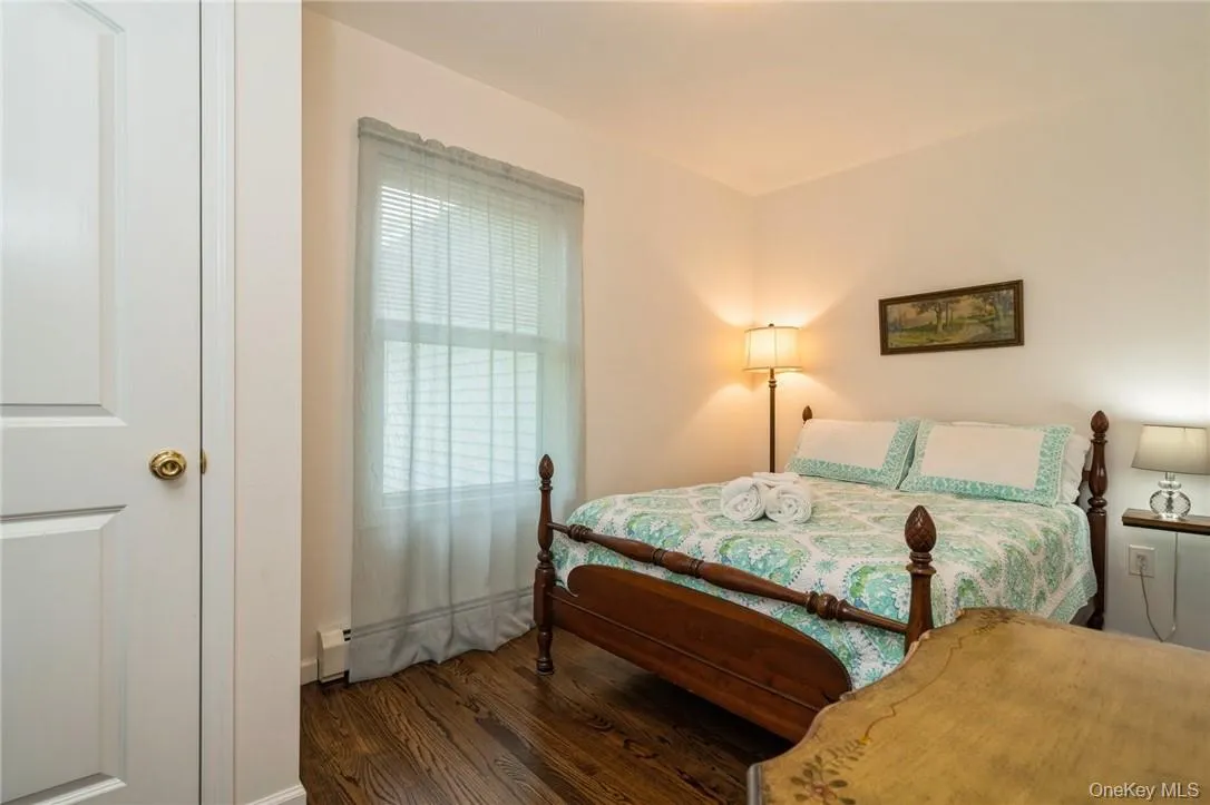 Bedroom featuring dark hardwood / wood-style floors Bedroom featuring dark hardwood / wood-style floors