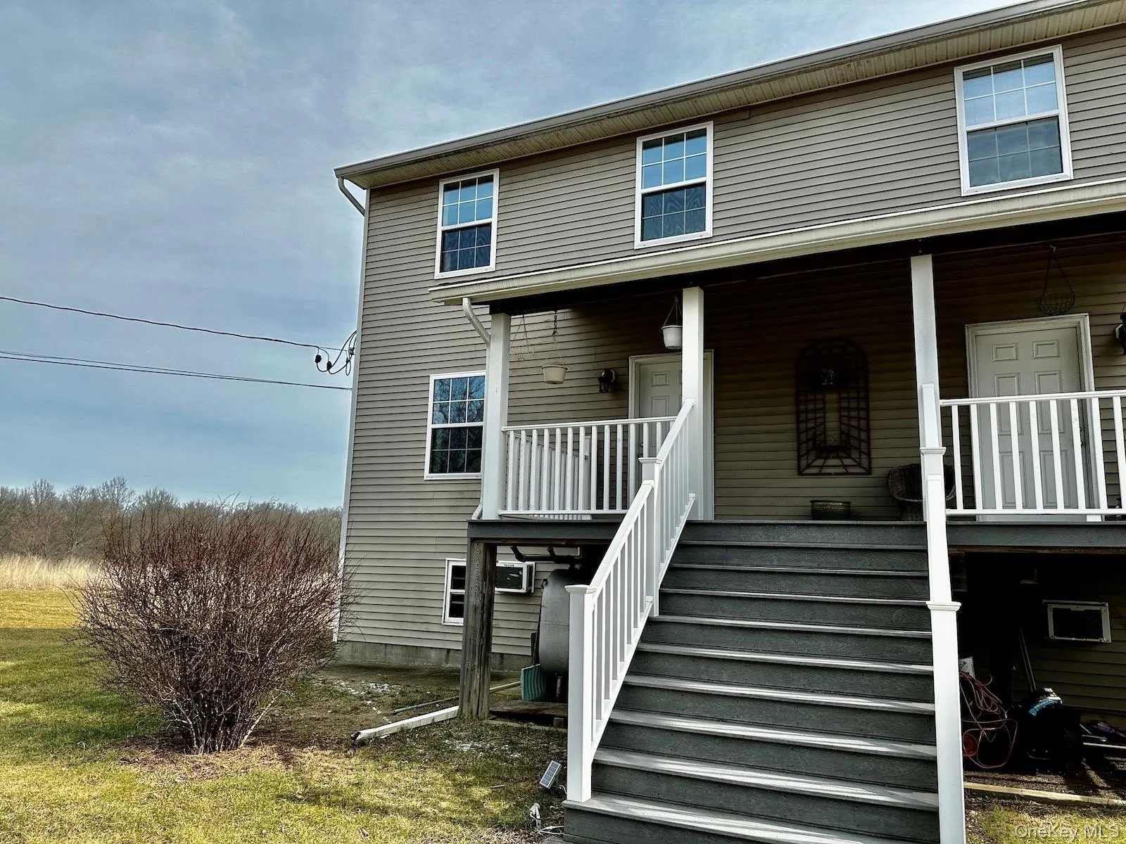 View of front facade featuring covered porch and stairs View of front facade featuring covered porch and stairs