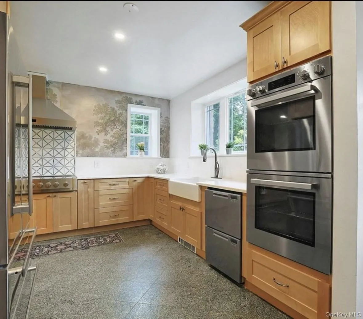 Kitchen featuring shaker-style wood cabinetry, stainless steel double wall ovens, a farmhouse sink with a gooseneck faucet, , and marble flooring Kitchen featuring shaker-style wood cabinetry, stainless steel double wall ovens, a farmhouse sink with a gooseneck faucet, , and marble flooring