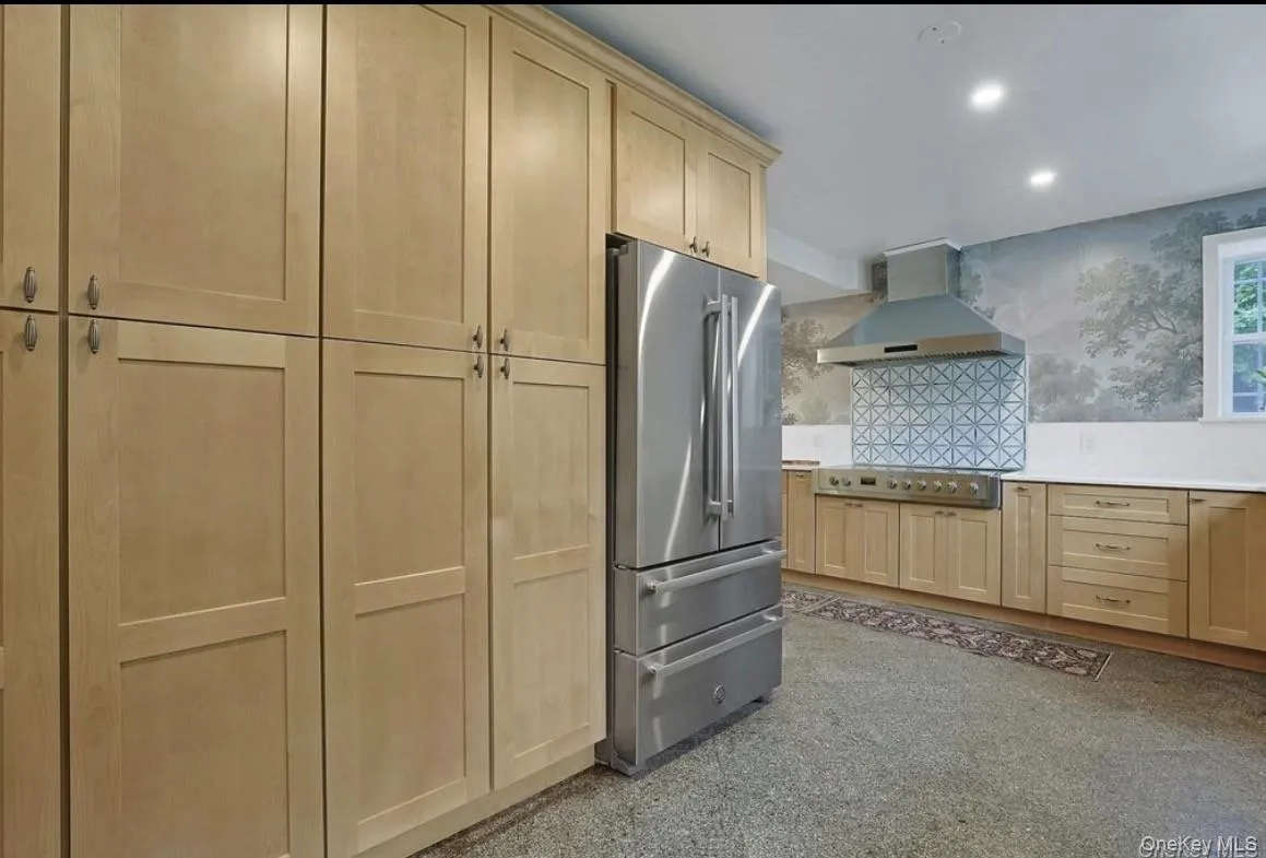 Kitchen featuring floor-to-ceiling pantry, stainless steel refrigerator, professional-style Kitchen featuring floor-to-ceiling pantry, stainless steel refrigerator, professional-style
