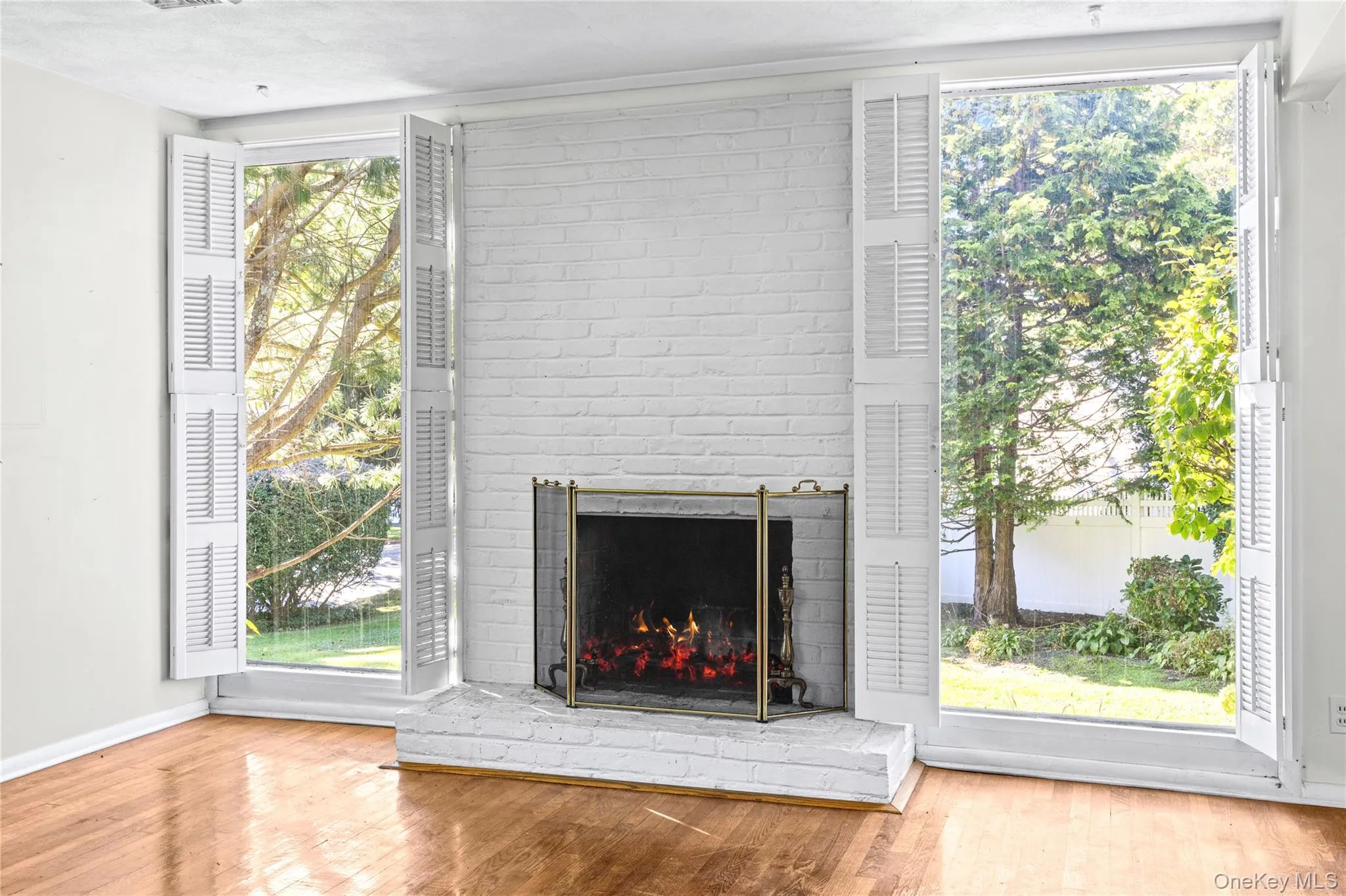 Pretty Brick Fireplace set between floor to ceiling glass- ABUNDANT LIGHT! Pretty Brick Fireplace set between floor to ceiling glass- ABUNDANT LIGHT!