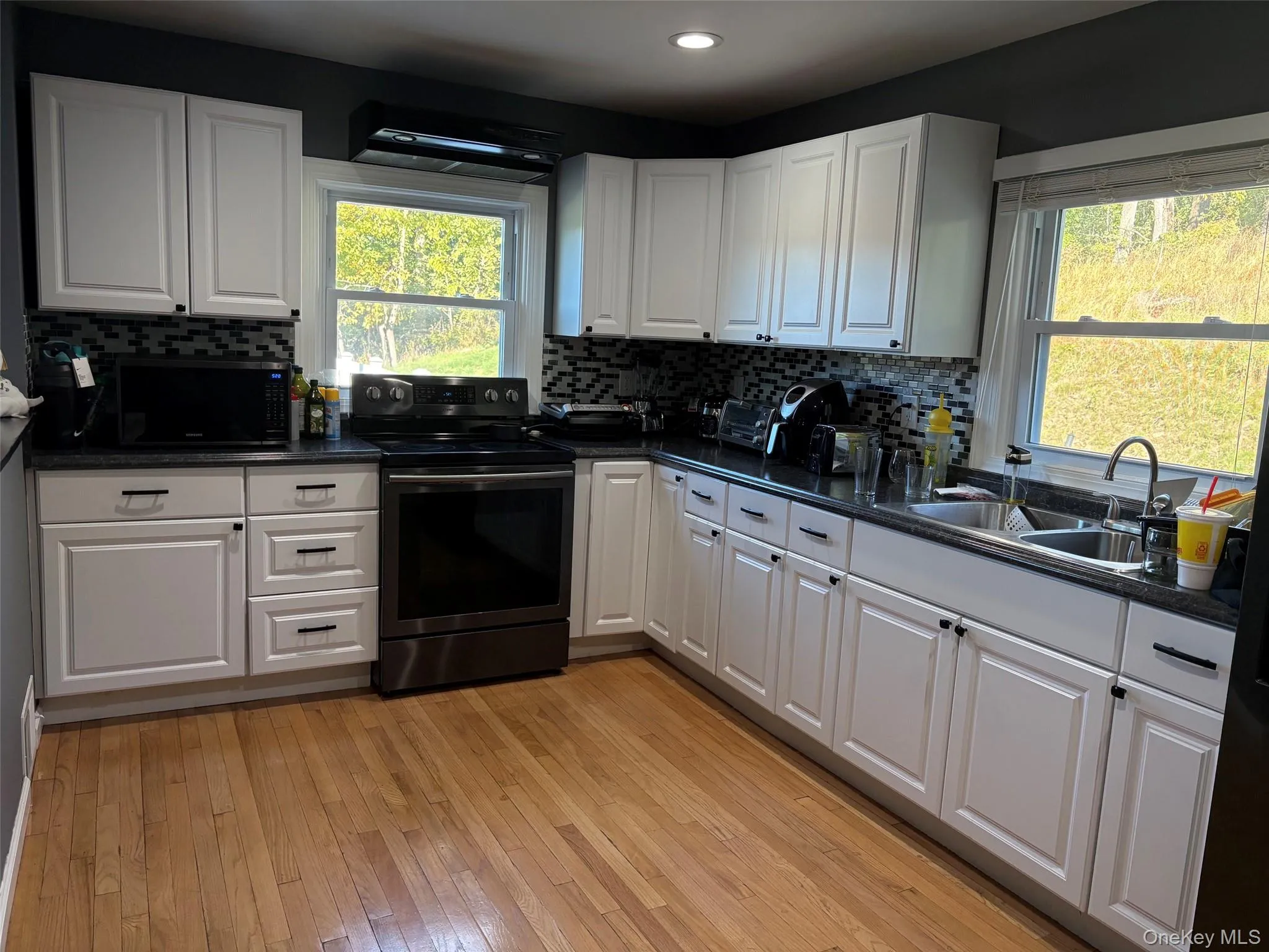 Spacious kitchen with black stainless steel appliances lots of natural light and cross ventilation with 2 windows. Spacious kitchen with black stainless steel appliances lots of natural light and cross ventilation with 2 windows.