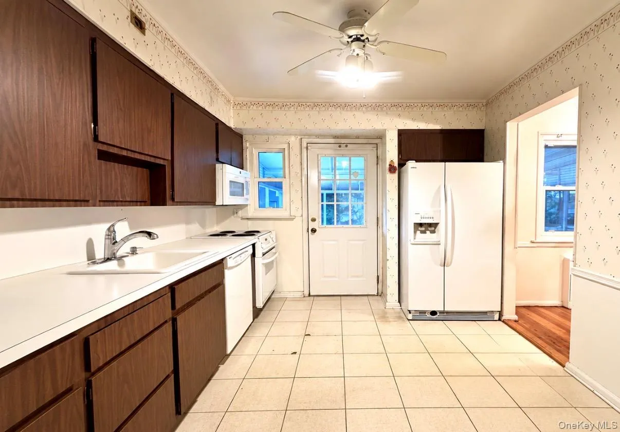 Eat In Kitchen featuring Side by Side Refrigerator, Electric Stove, Over The Stove Microwave and Dishwasher Eat In Kitchen featuring Side by Side Refrigerator, Electric Stove, Over The Stove Microwave and Dishwasher