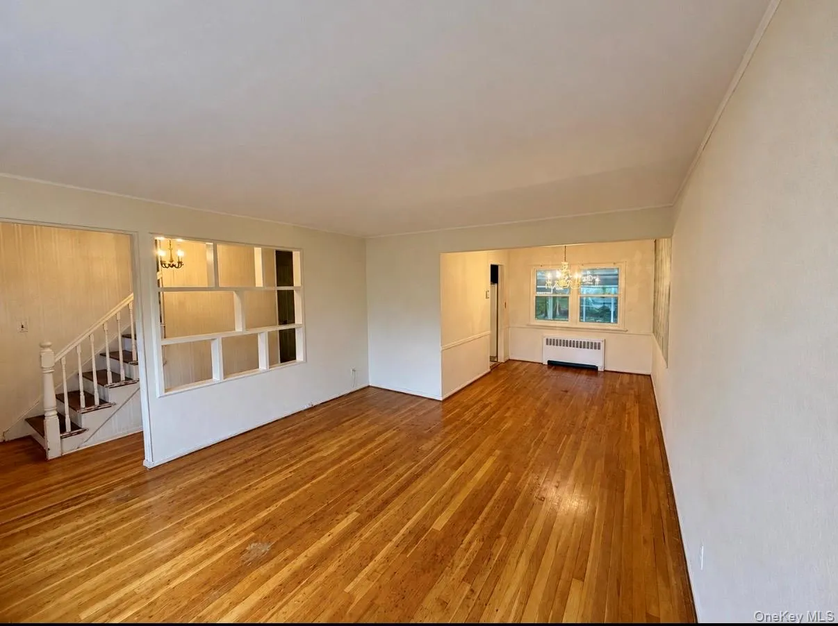 Living Room View Of hallway and Dining Room. Featuring hardwood flooring Living Room View Of hallway and Dining Room. Featuring hardwood flooring